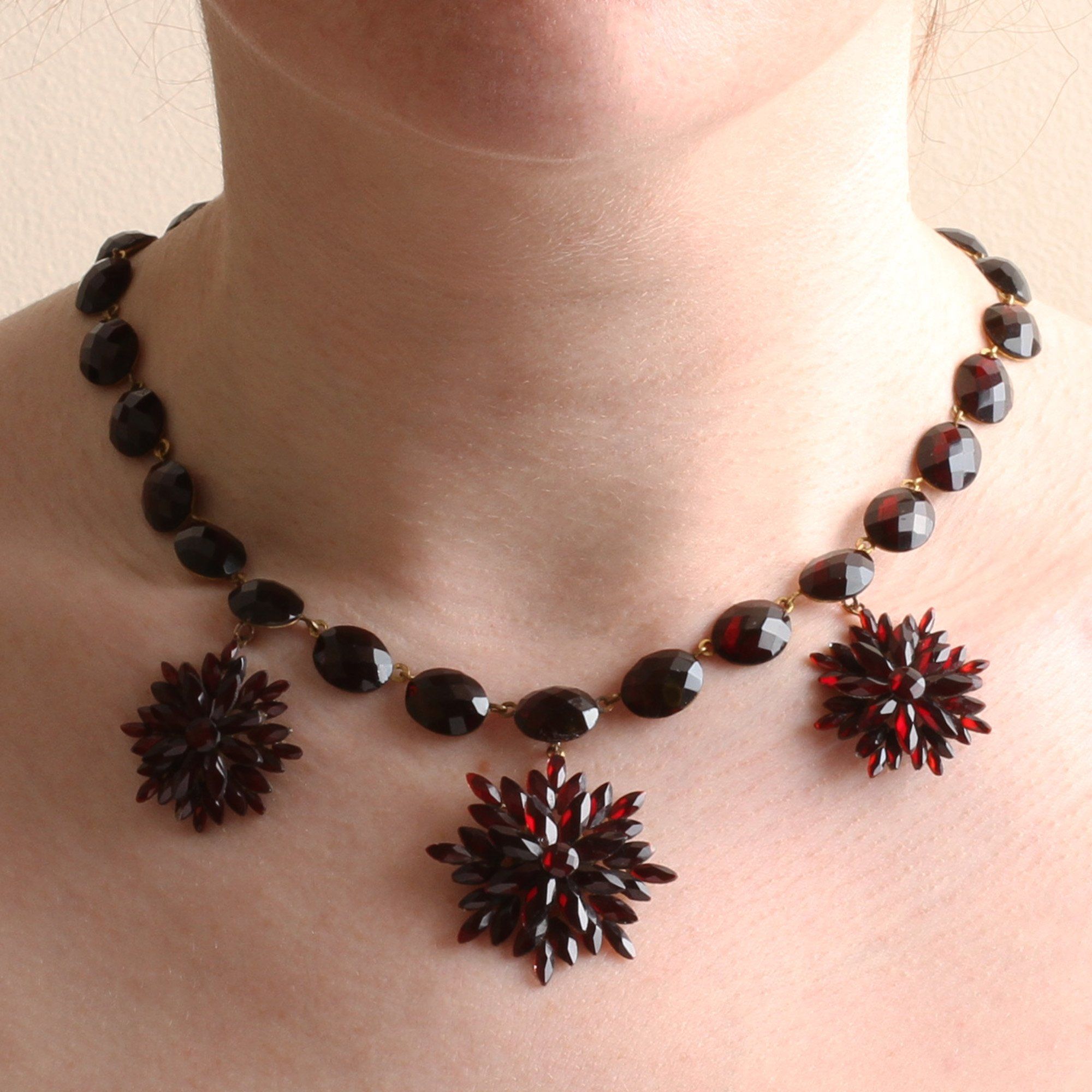Closeup of someone wearing the Red Vauxhall Glass Necklace