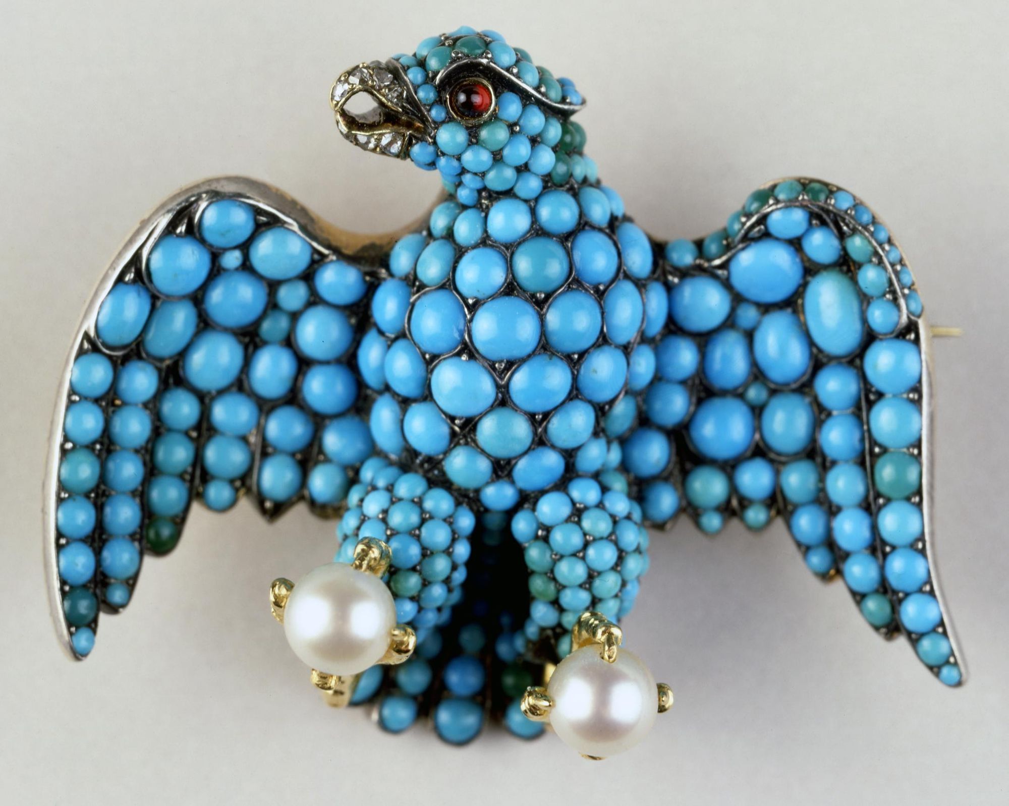 Brooch in the form of the Coburg eagle, with pave-set turquoises designed by Prince Albert given to the Queen Victoria's train bearers. In the collection of the British Museum