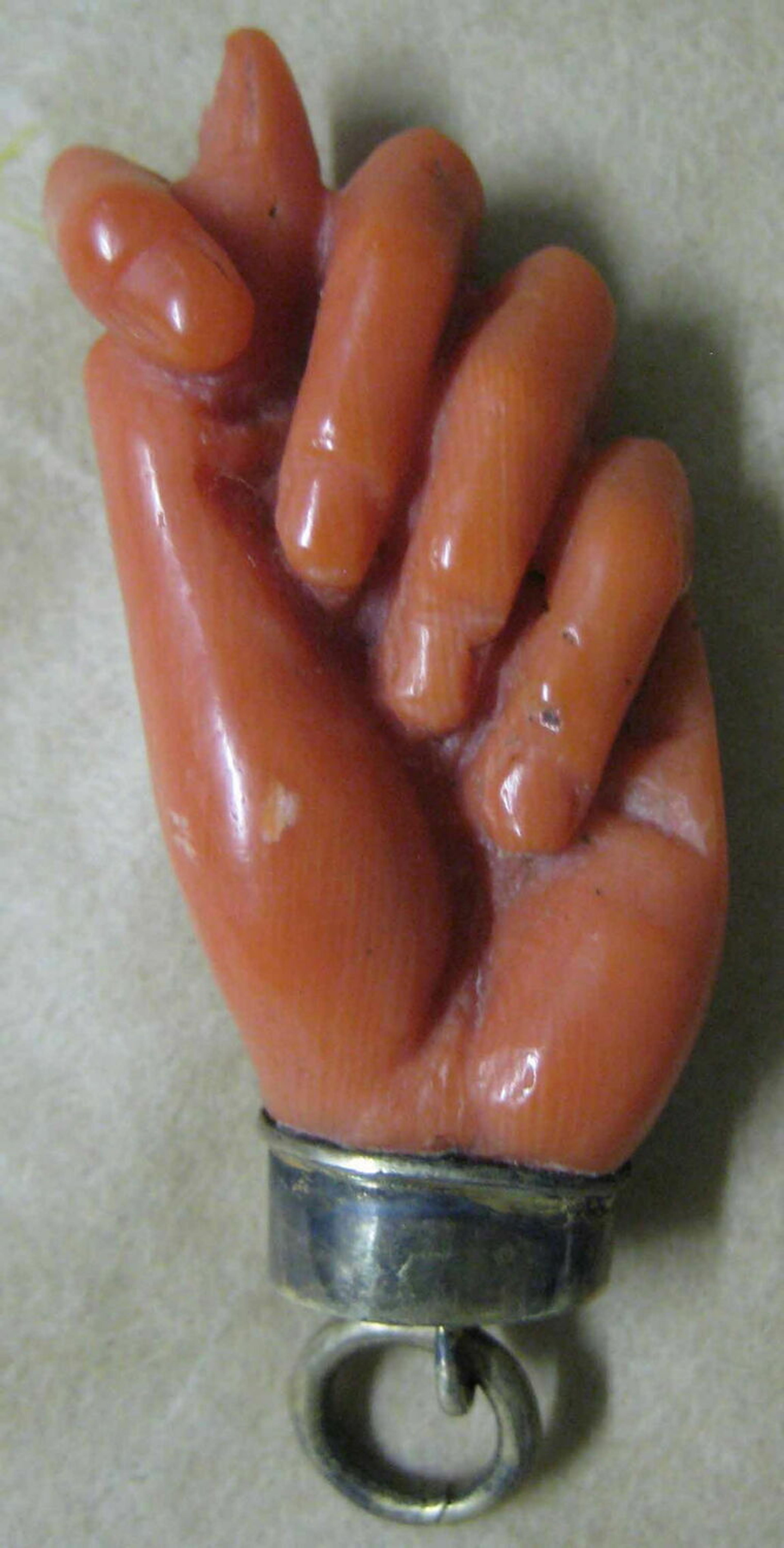 Pendant: coral hand with setting and ring, Louvre Museum.