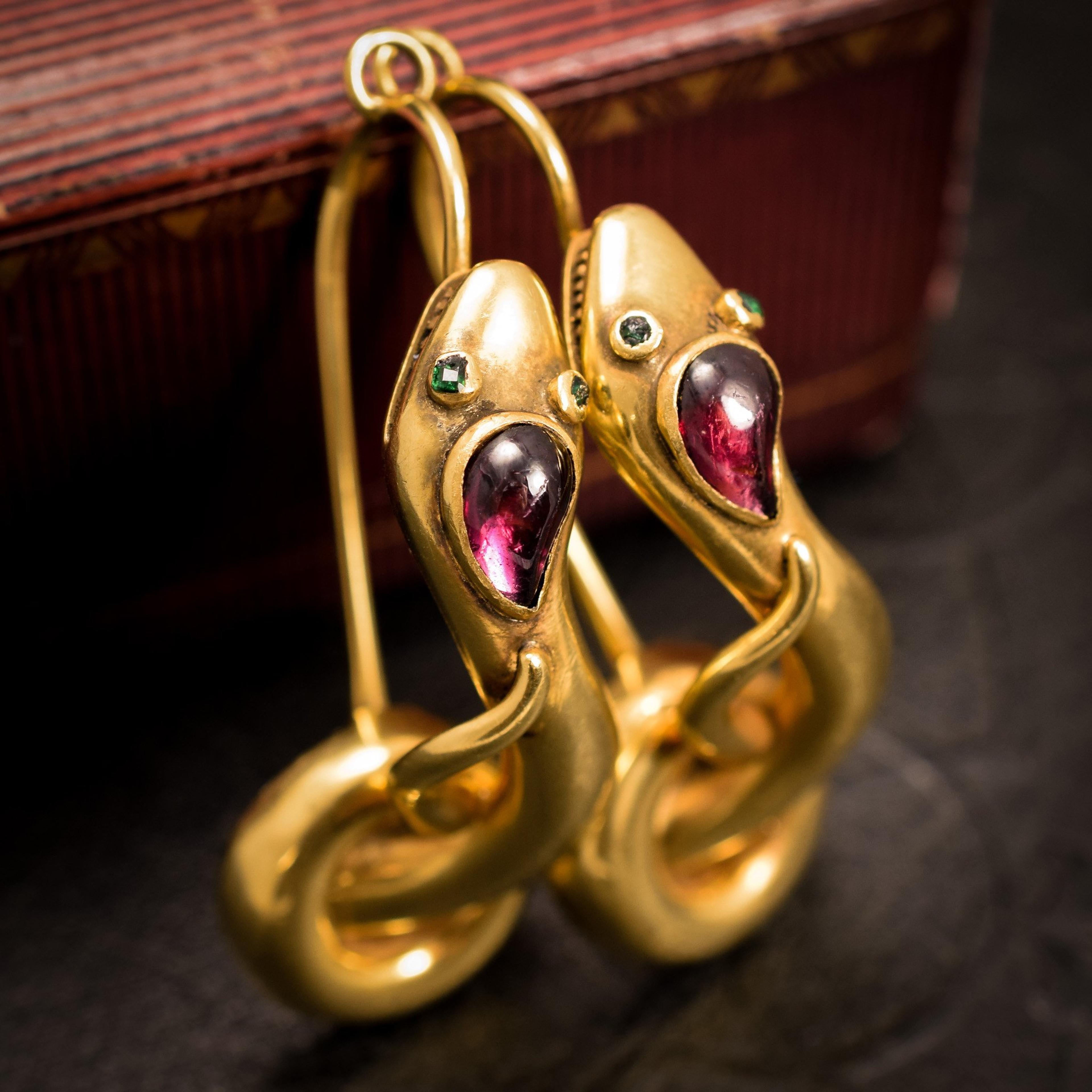 Detail of Serpent Earrings with Garnet Cabochons and Emerald Eyes