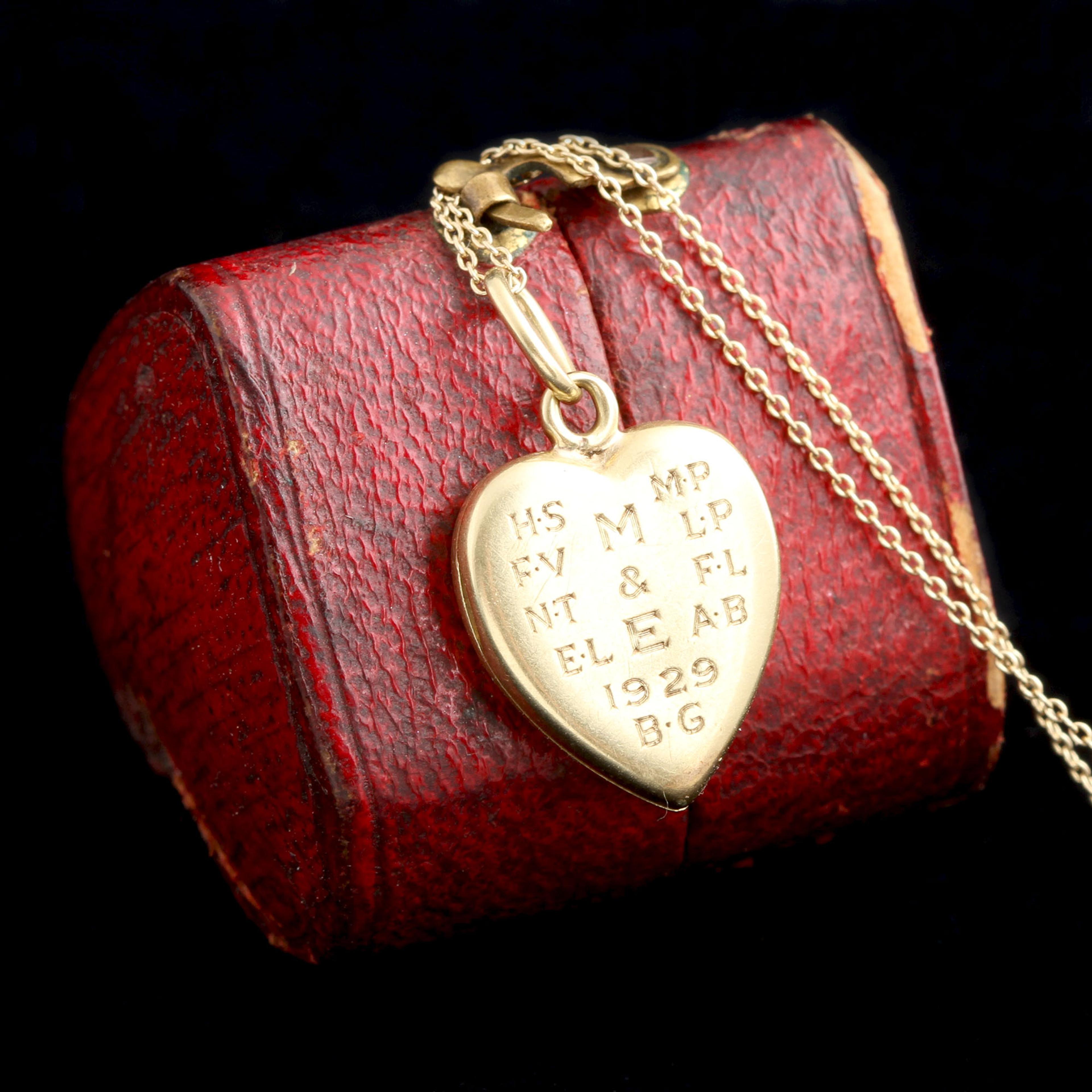 Detail of 1920s M & E Enamel Heart Locket Necklace showing back side engraving