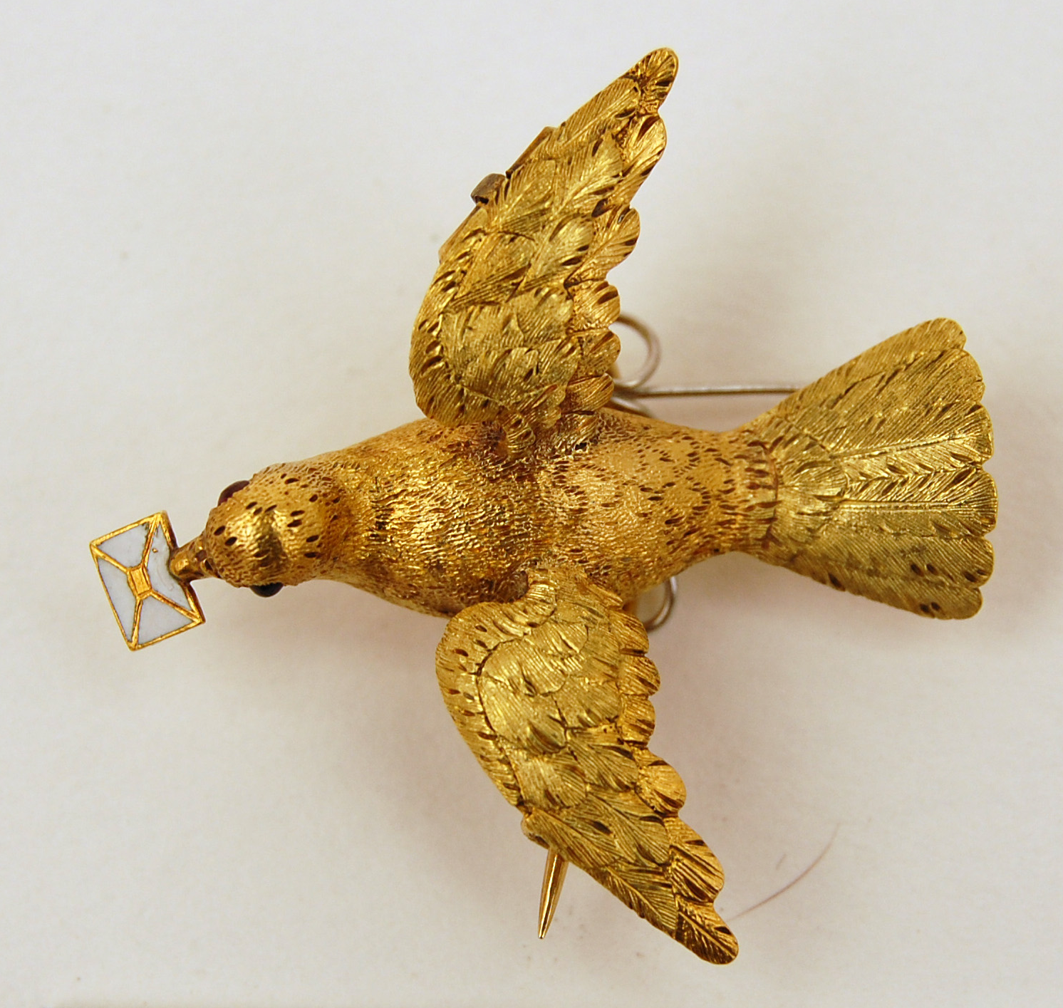 Gold dove holding a white enameled envelope, 1850. The British Museum.