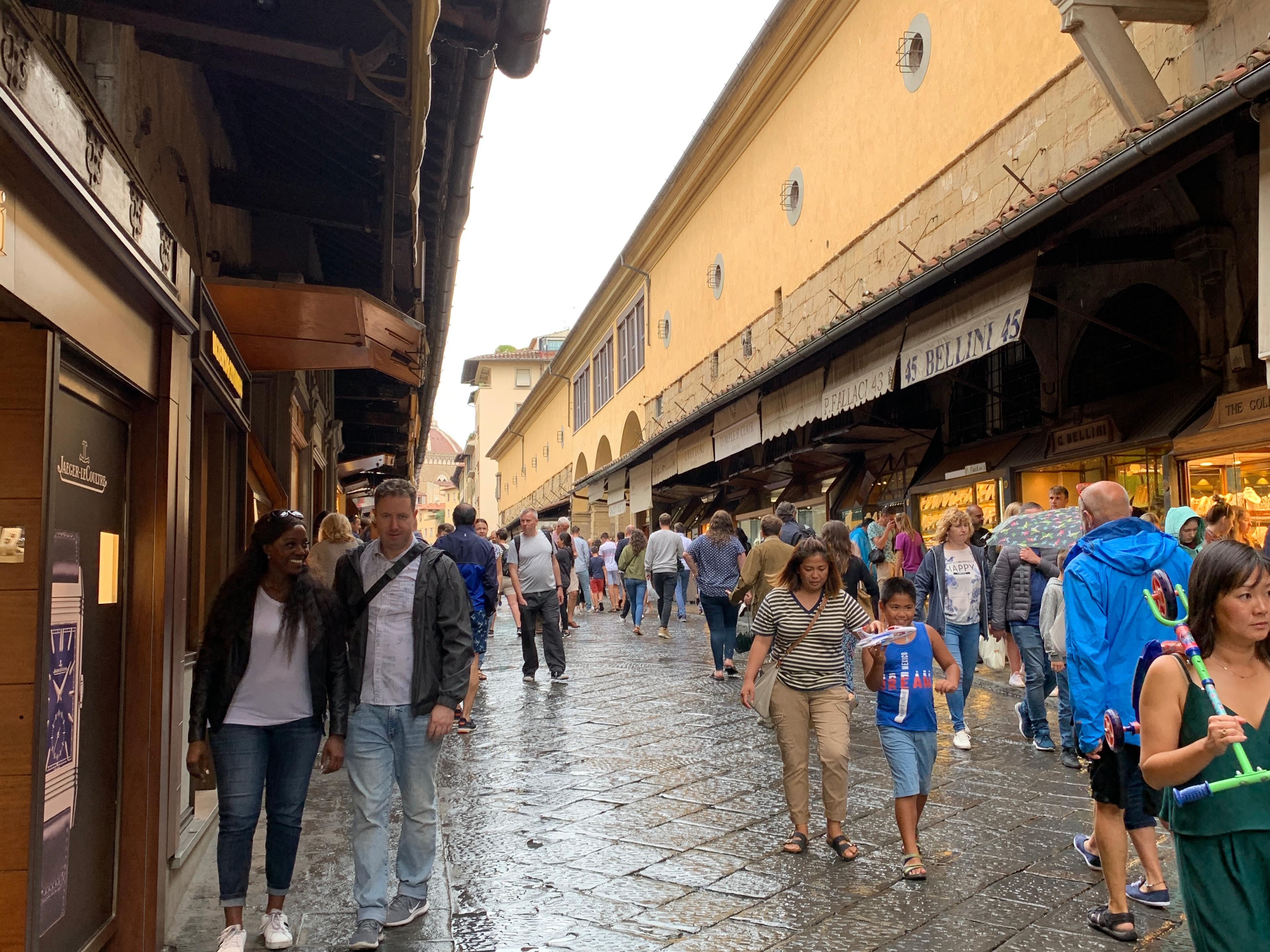 Tourists (like me!) shopping for souvenirs on the Ponte Vecchio, Florence, 2019.