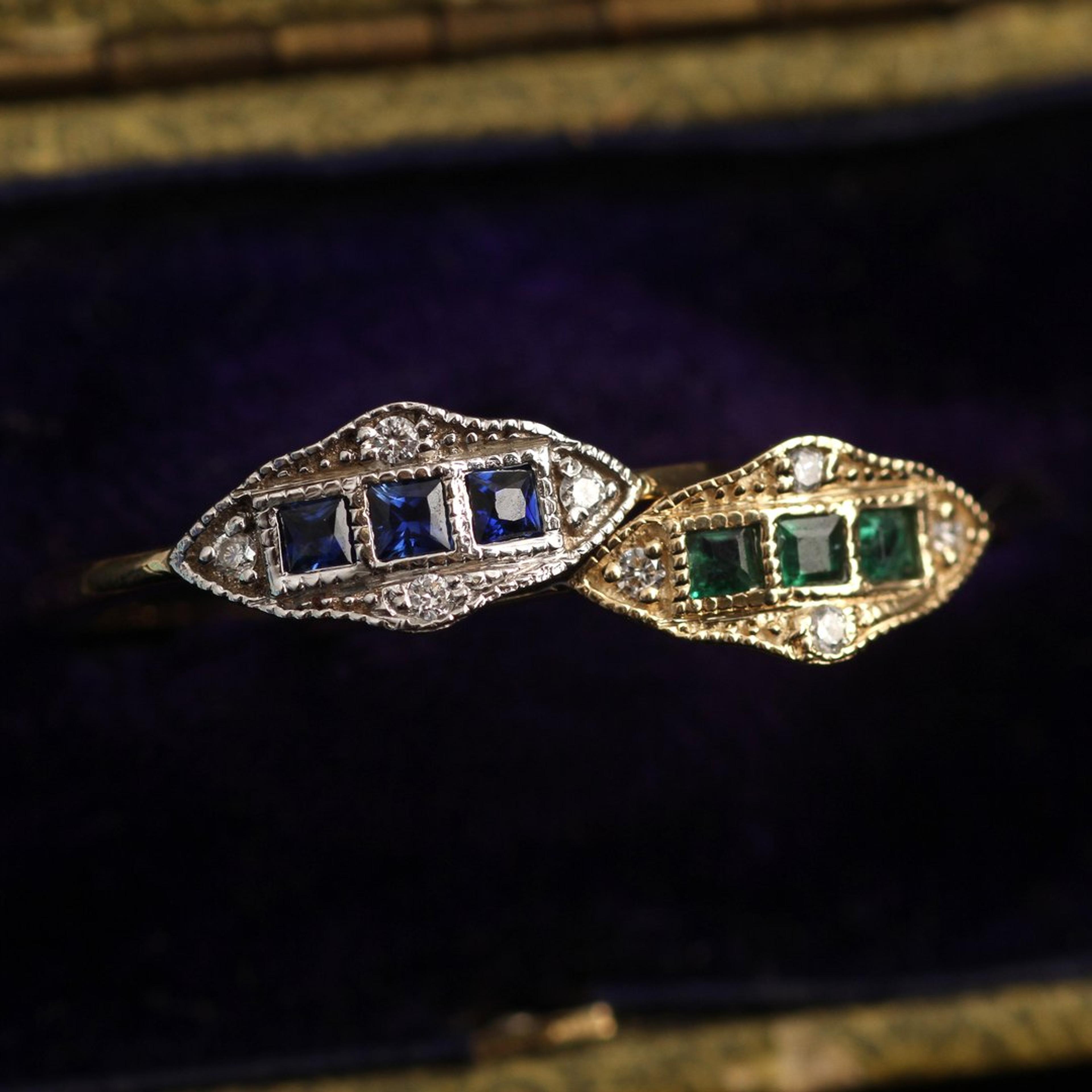 Close up of two Machine Age Rings, one with sapphires, one with emeralds