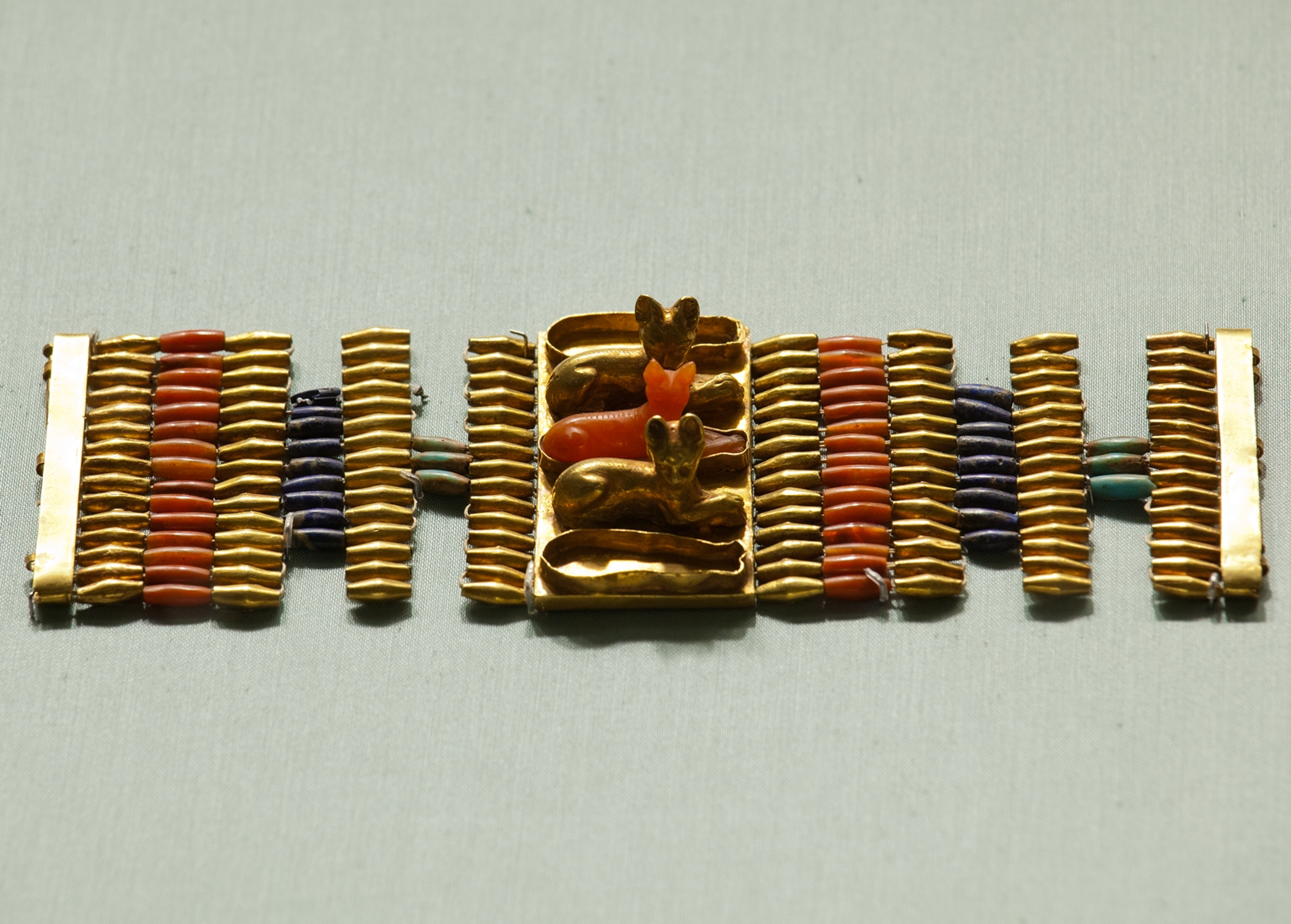 Cuff bracelet decorated with cats. The gold bracelet is accented with carnelian, lapis-lazuli and turquoise glass, 1479-1425 B.C. The Metropolitan Museum of Art.