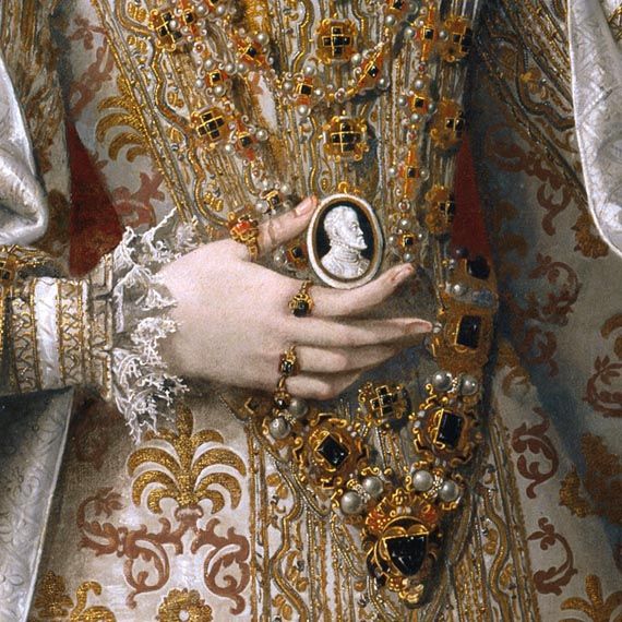 In this portrait detail Infanta Isabella Clara Eugenia is holding a cameo portrait of her father, Spain's Phillip II, as a symbol of her dynastic right and alliThe infanta Isabella Clara Eugenia and Magdalena Ruiz. Alonso Sánchez Coello and workshop, Benifairó de les Valls, Valencia c.1531 – 1588. Museo Nacional del Prado 