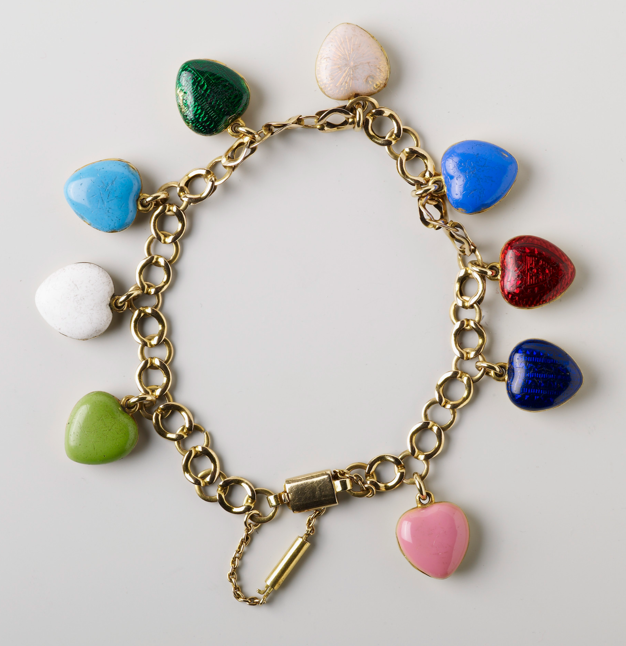 Queen Victoria's bracelet with lockets for each child: pink for Princess Victoria, turquoise blue for Albert, red for Princess Alice, dark blue for Alfred, translucent white for Helena, dark green for Louise, mid blue for Arthur, opaque white for Leopold and light green for Beatrice
