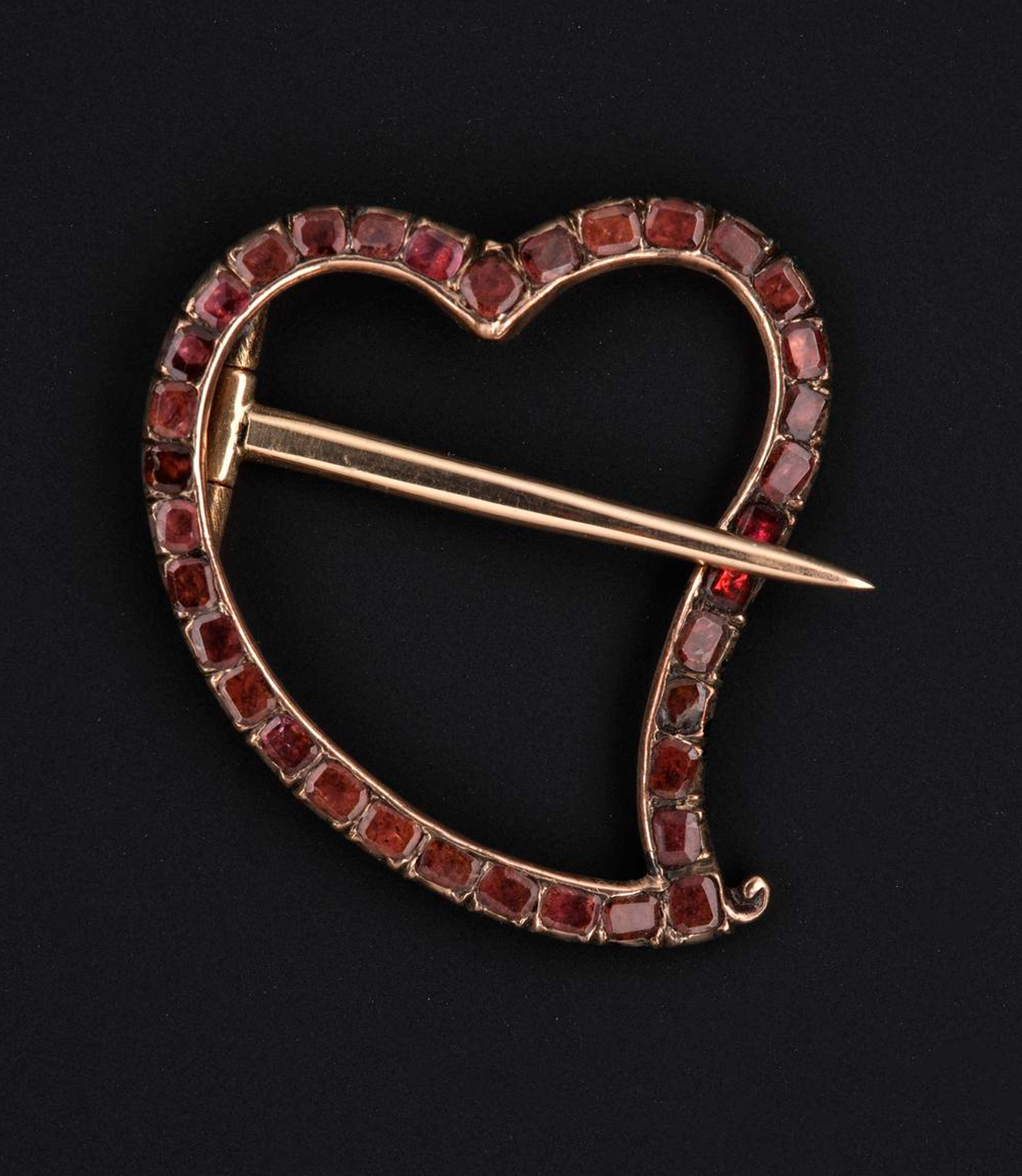 When the heart's tail curves to the right, it's known as a "witch's heart". By the 18th century, its meaning have evolved from a protective talisman to indicting that one was "bewitched" in love. S
