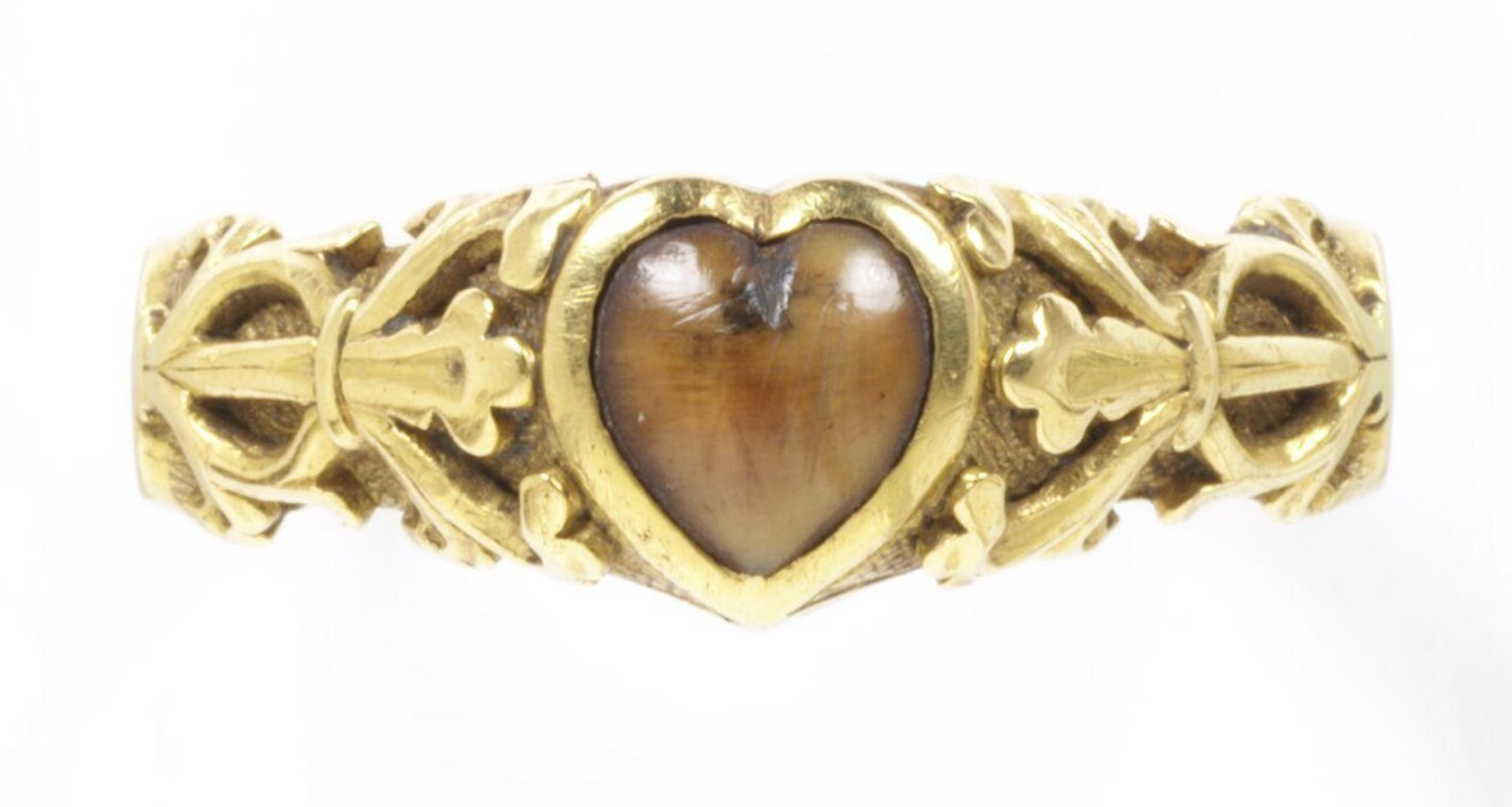 A wolf-tooth set in a heart-shaped bezel. The ring is inscribed with a magical charm to protect against toothache: "Buro + Berto + Berneto" as well as the words "Cosummatum + Est" - the last words Christ was said to have spoken on the cross and were used as a charm to calm storms. c. 14th century, The Victoria & Albert Museum. 