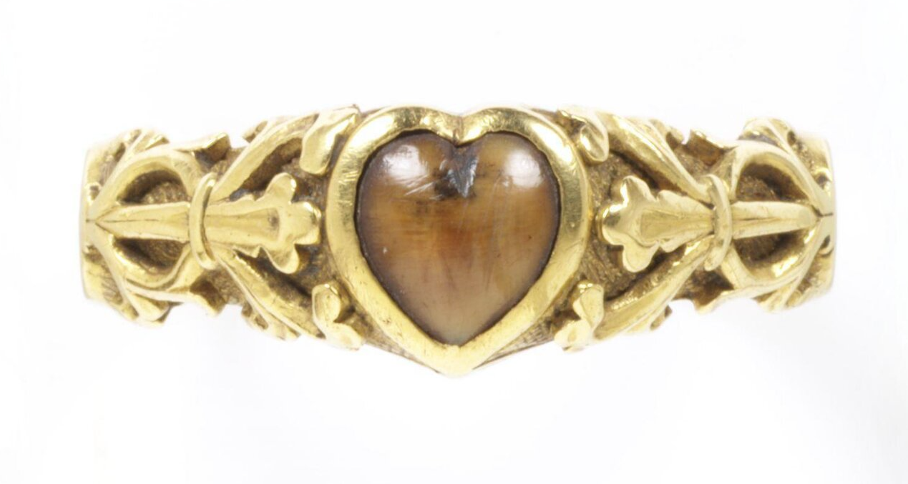 A wolf-tooth set in a heart-shaped bezel. The ring is inscribed with a magical charm to protect against toothache: "Buro + Berto + Berneto" as well as the words "Cosummatum + Est" - the last words Christ was said to have spoken on the cross and were used as a charm to calm storms. c. 14th century, The Victoria & Albert Museum.