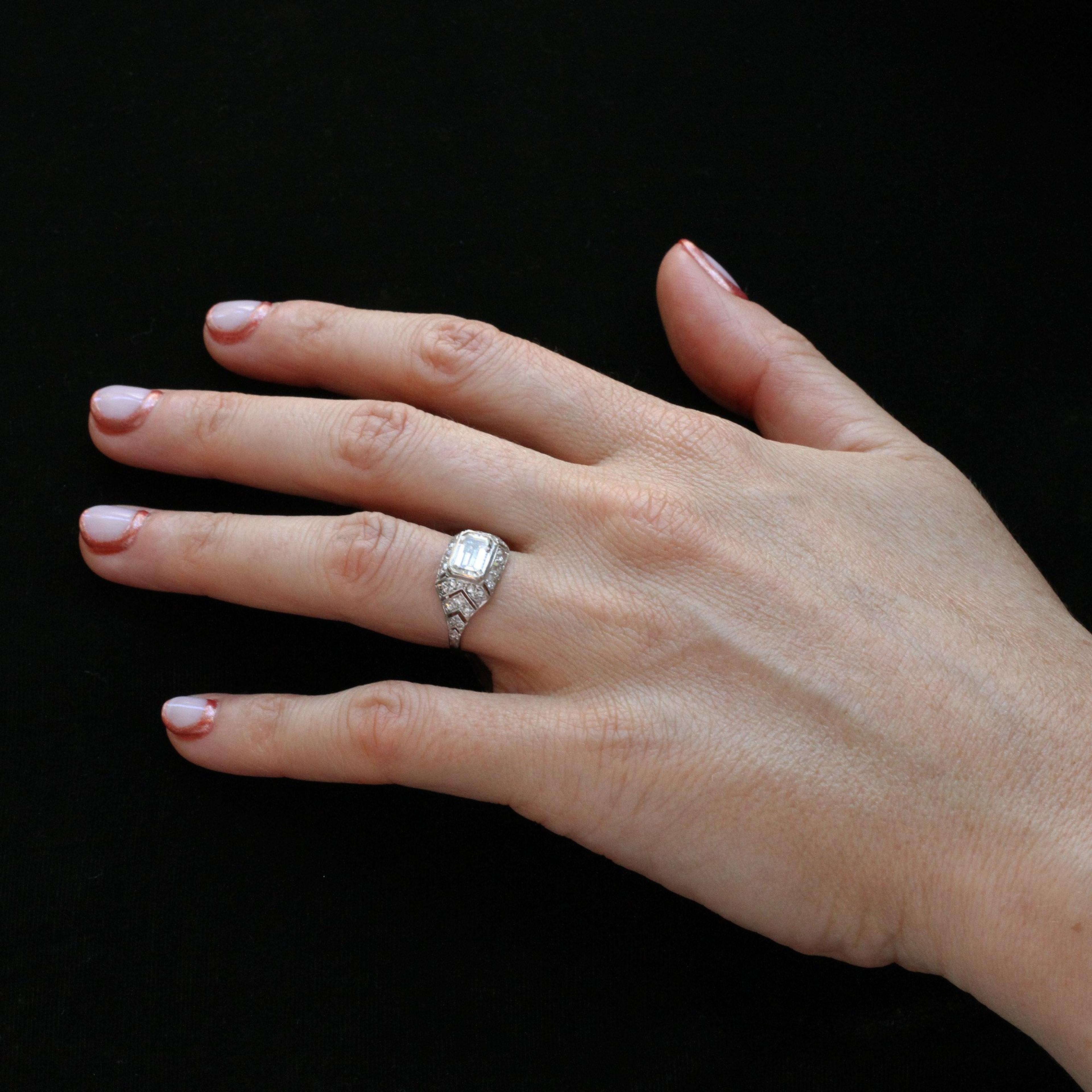 Closeup of Art Deco 1.10ct Emerald Cut Diamond Chevron Engagement Ring worn on the ring finger