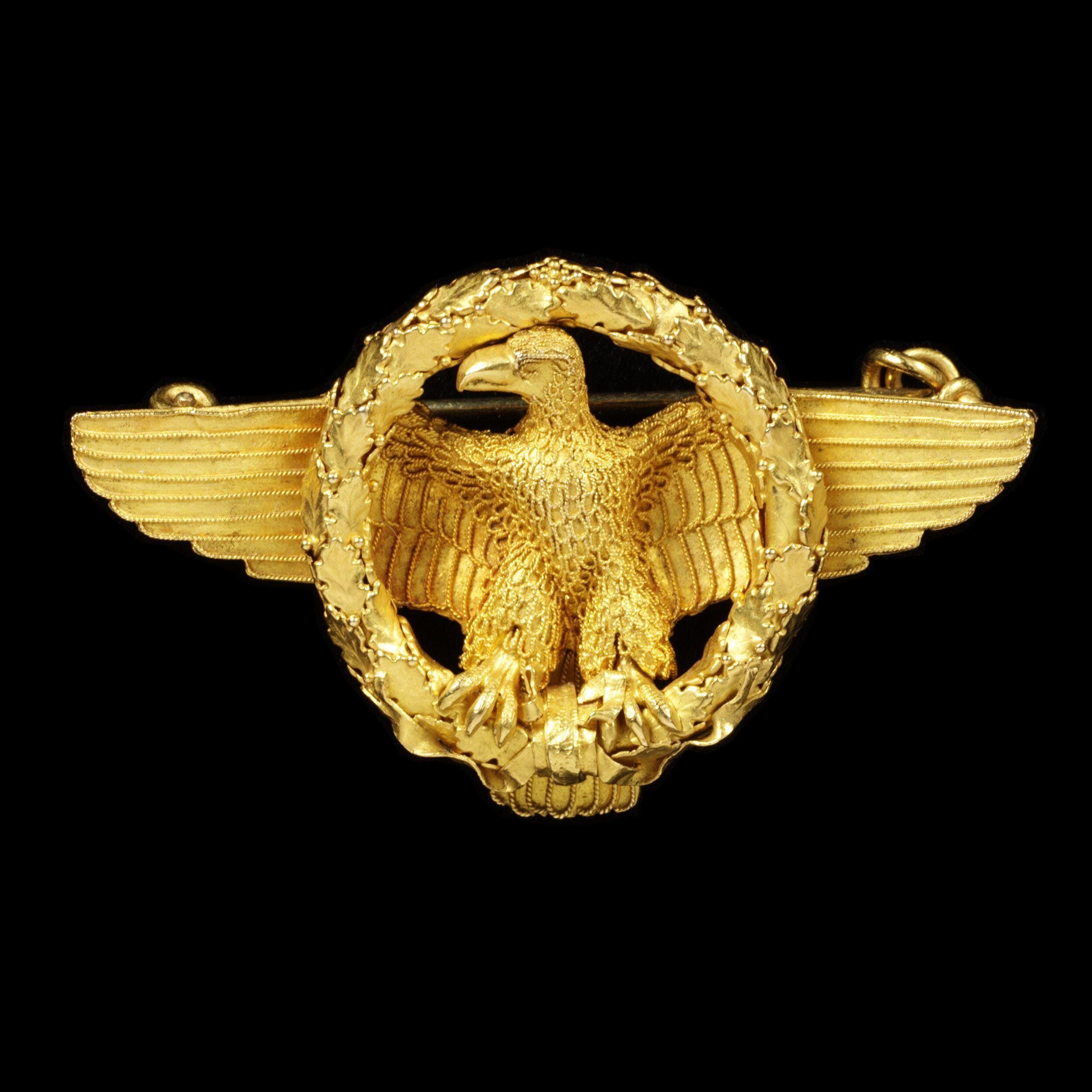 A brooch by Castellani of Rome, the leading firm making jewelry inspired by archaeological finds is in the form of an ensign of a Roman legion. Each legion carried a standard which took the form of an eagle. The loss of the standard was a terrible disgrace. Brooch, 1860. The Victoria & Albert Museum.