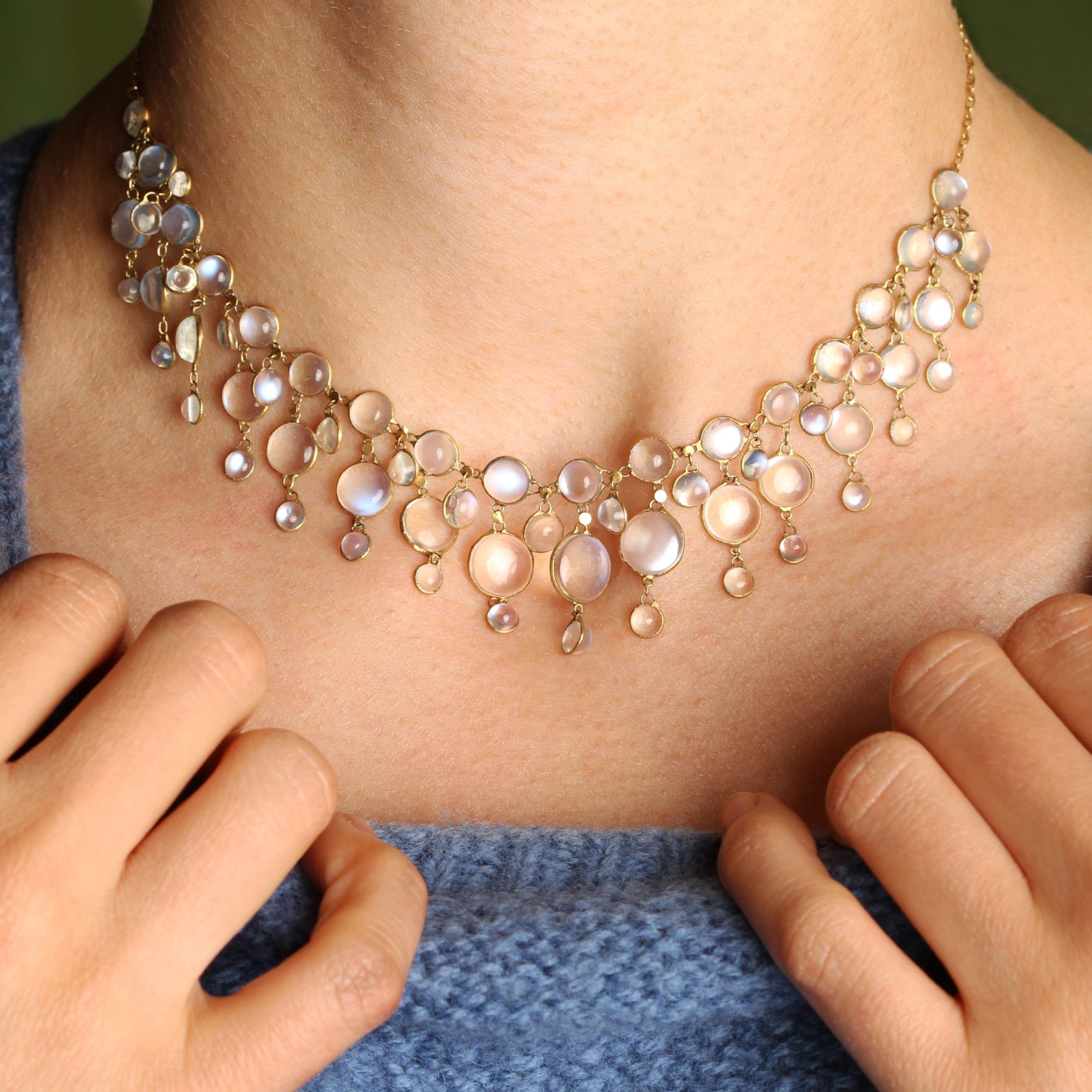 Closeup of someone wearing the Art Nouveau Moonstone Fringe Collar