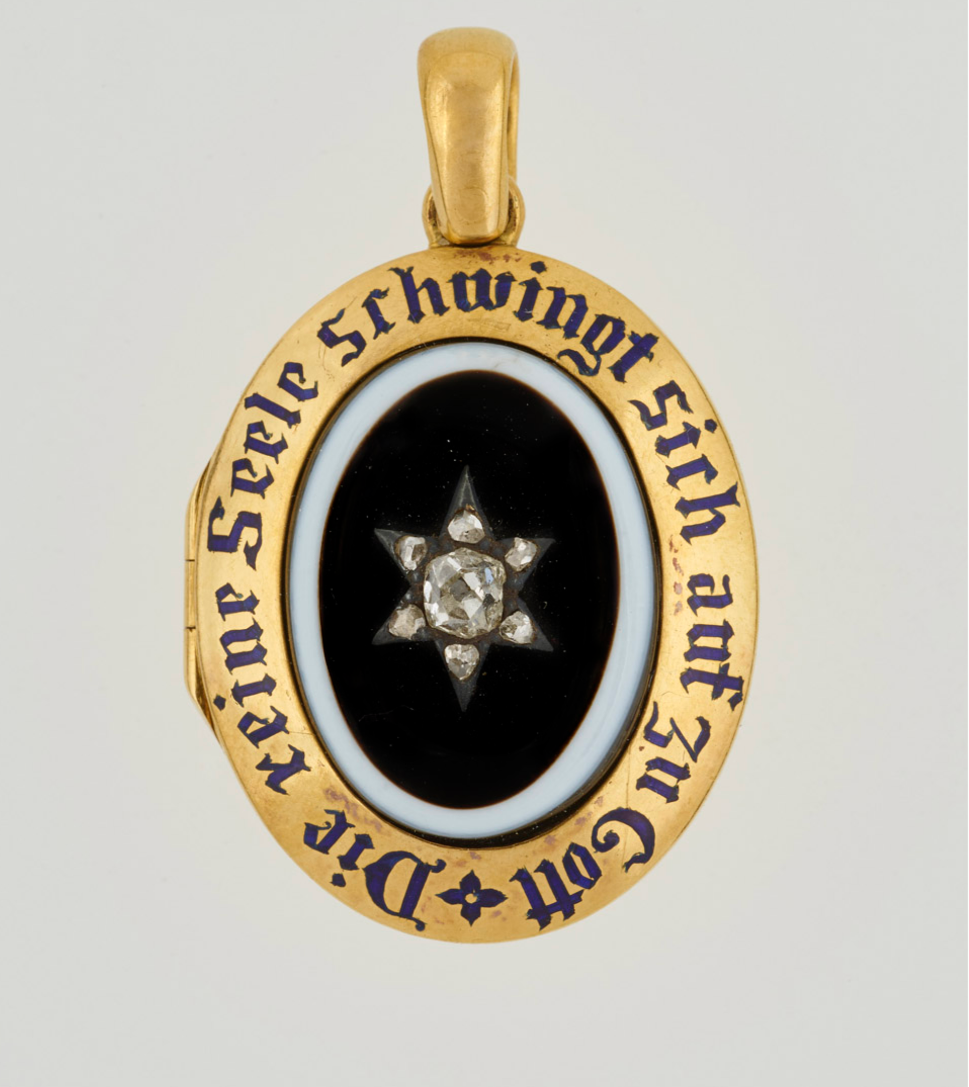 A locket belonging to Queen Victoria, set with central oval onyx, black on white, with diamond star set in plain gold border with blue enamel inscription: "The pure soul flies up above to the Lord" 