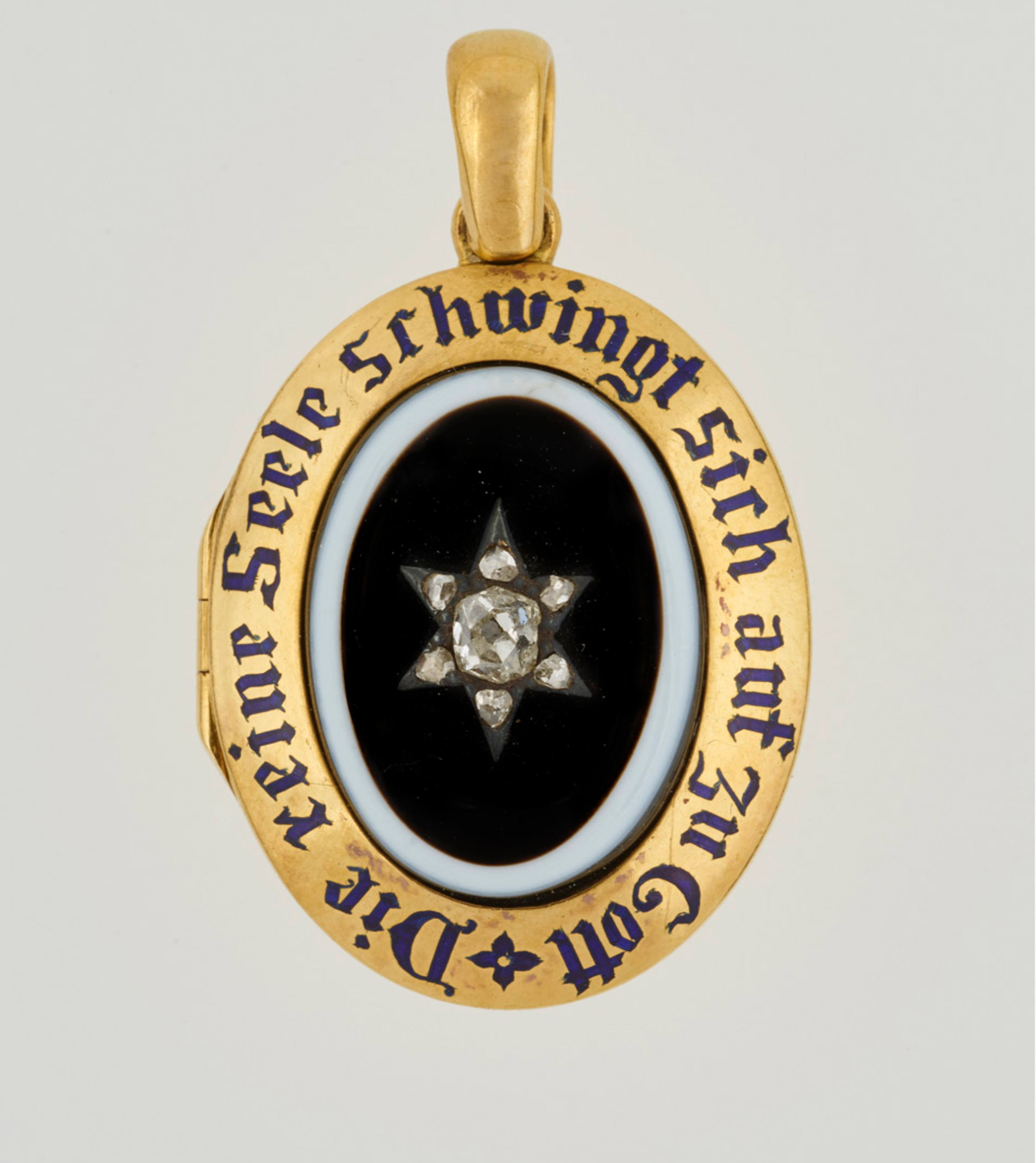 A locket belonging to Queen Victoria, set with central oval onyx, black on white, with diamond star set in plain gold border with blue enamel inscription: "The pure soul flies up above to the Lord"