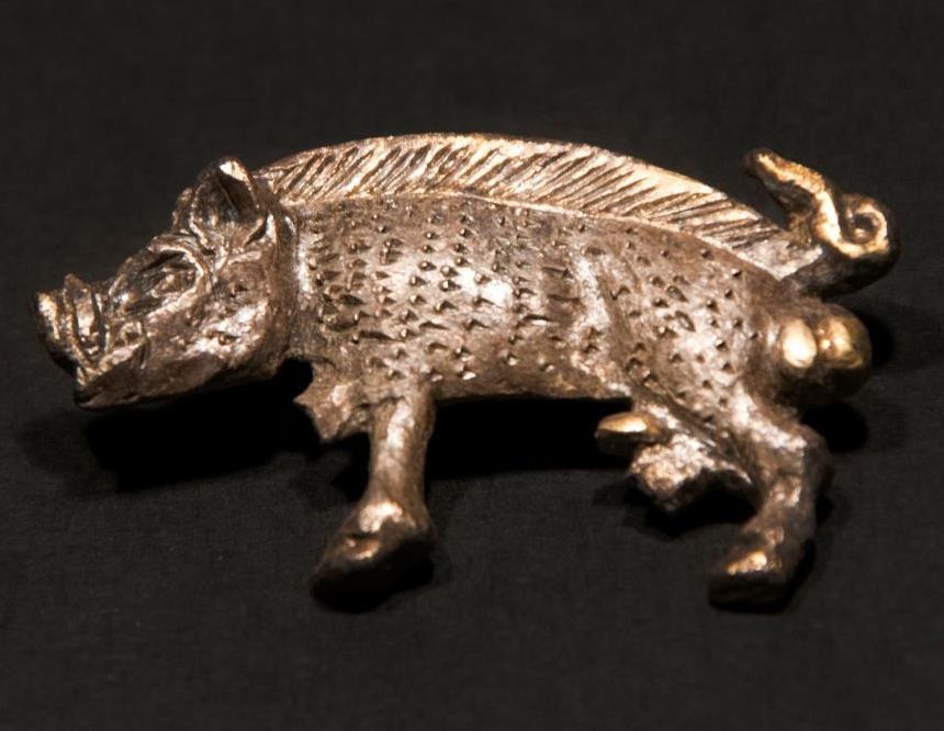 Silver gilt livery badge depicting a white boar. This device was used by Richard III, the last king of the House of York. He had thousand of low value badges man (The logo t-shirt of its time). (This example was likely worn as a hat pin), c. 1483. Yorkshire Museum.