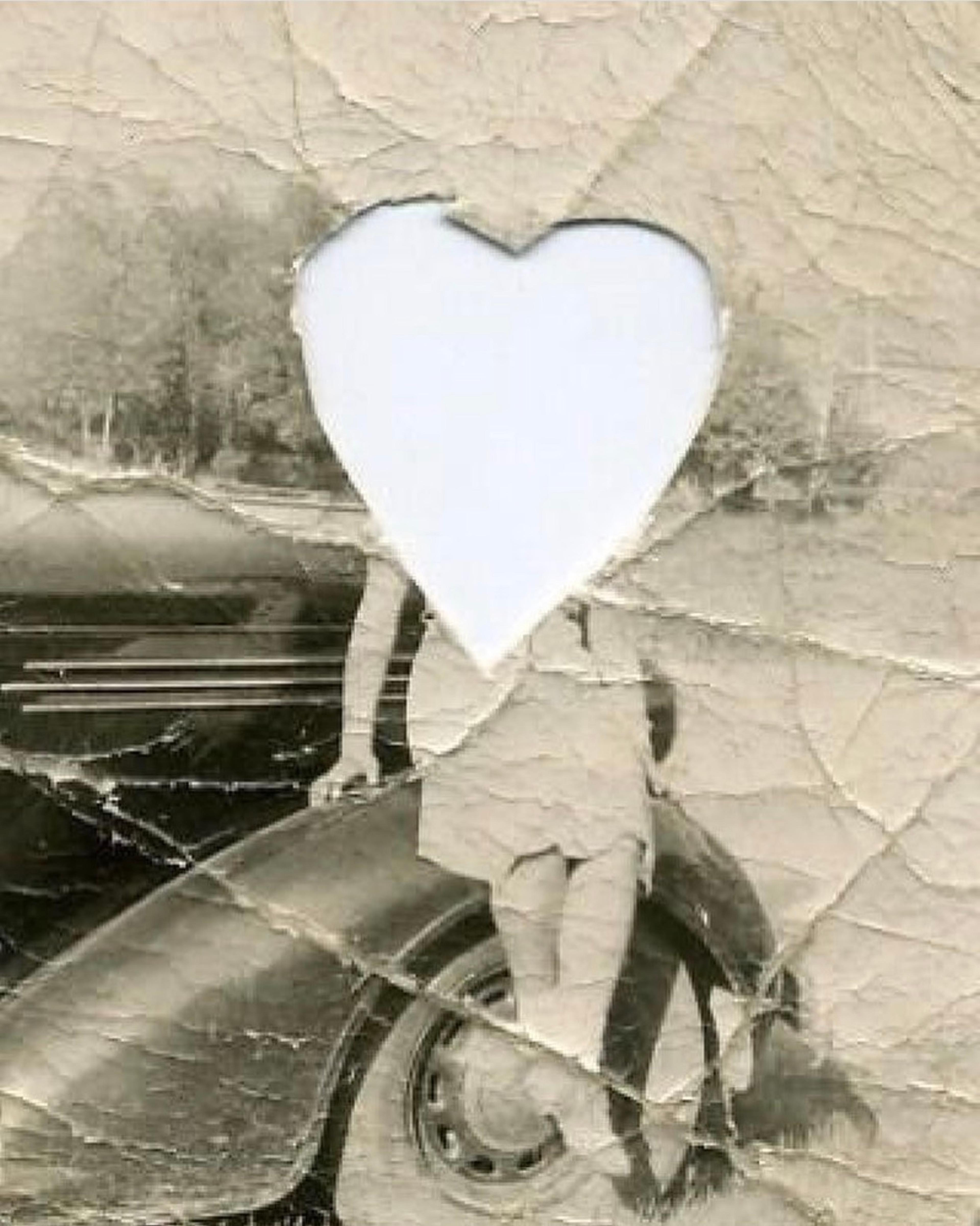 A black and white photo of a woman with a heart shape cut-out over her face.