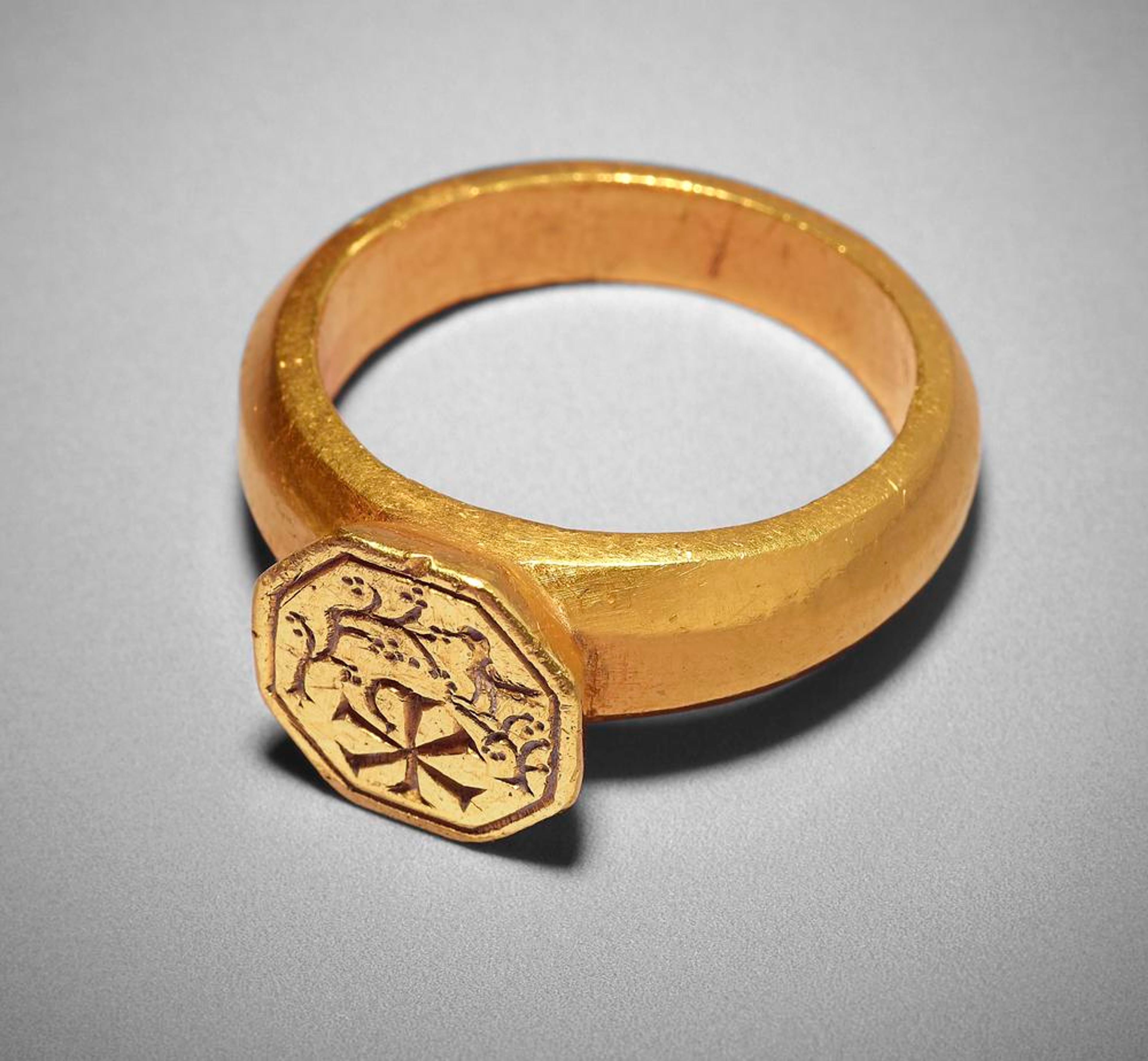 This 4th century ring bears the chi-rho monogram to indicate that its wearer was a Christian.Gold ring with raised octagonal bezel, The British Museum.