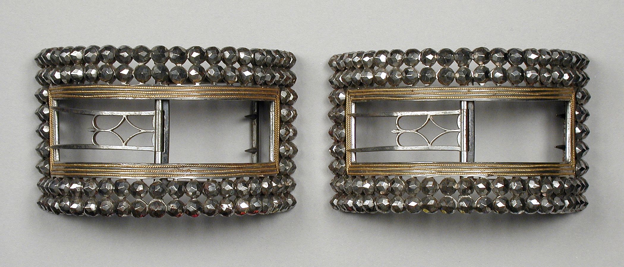 Cut steel shoe buckles with gold edging,  English, 1780s. The Los Angeles County Museum of Arts. 
