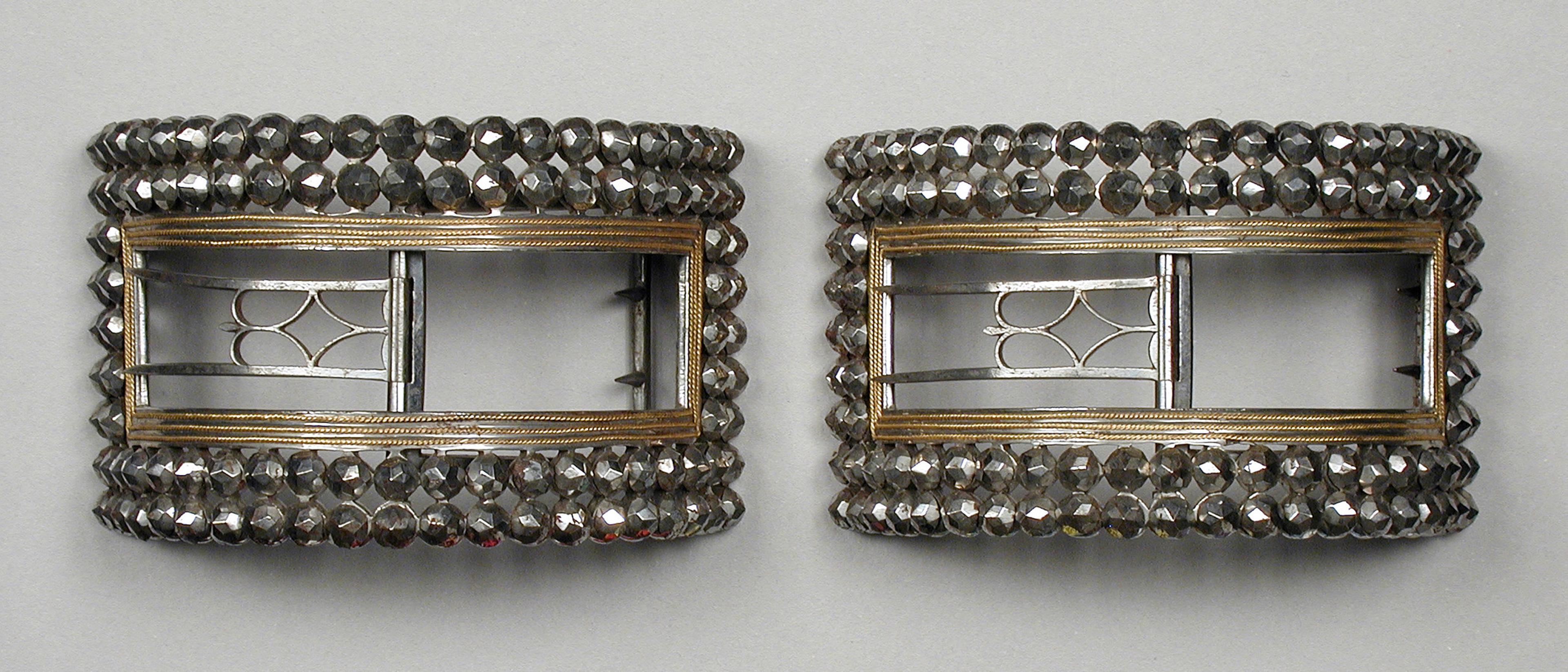 Cut steel shoe buckles with gold edging, English, 1780s. The Los Angeles County Museum of Arts.