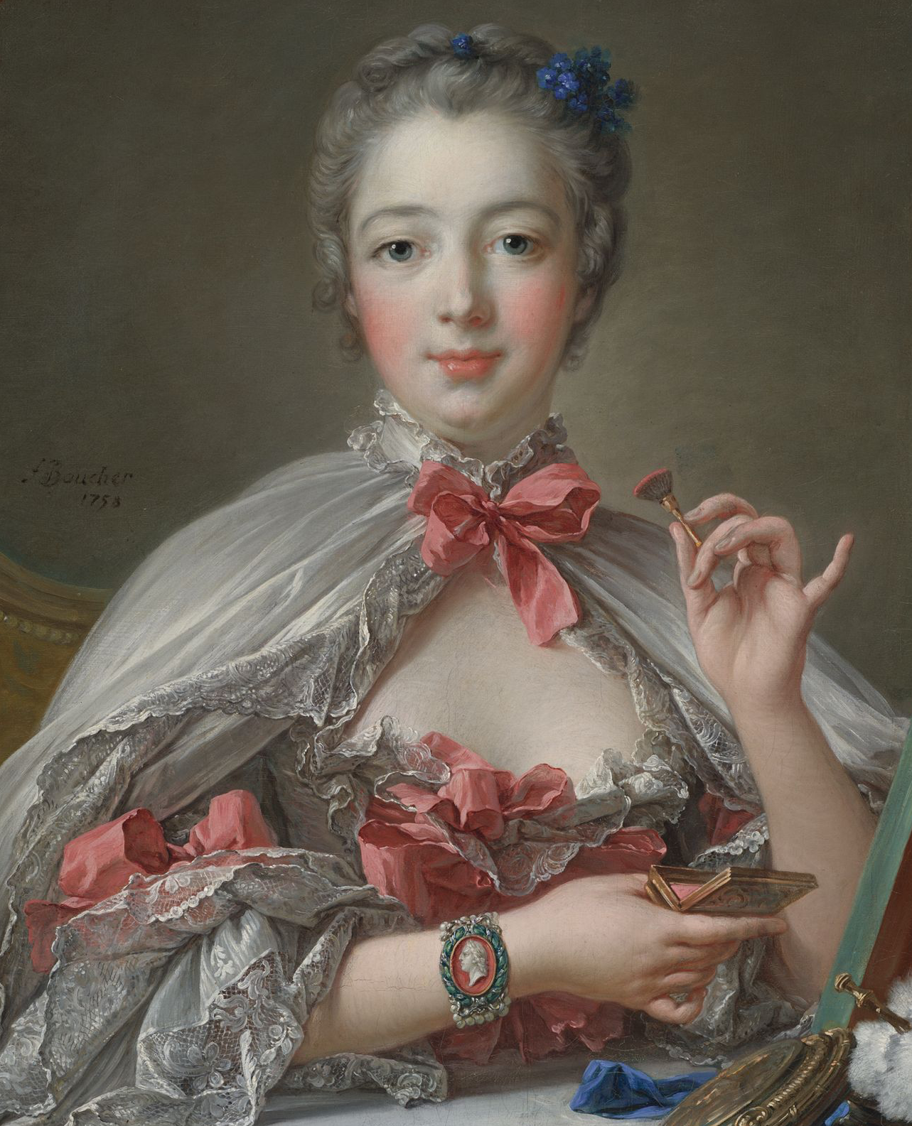 Official mistress of King Louis XV in 1745, Marquise de Pompadour wears a cameo bracelet depicting the King.Pompadour at her toilette by François Boucher, 1750. Harvard Museum. 