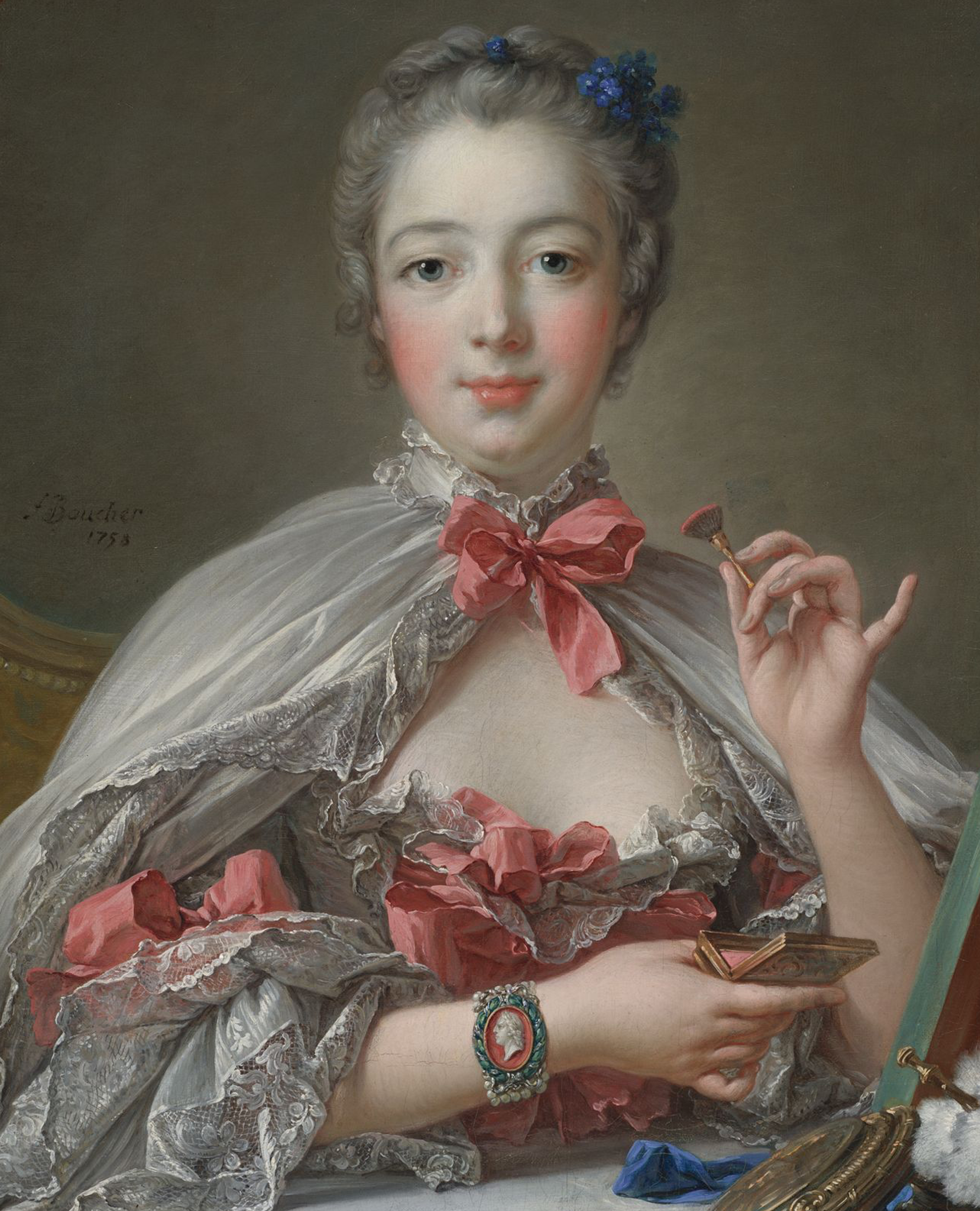 Official mistress of King Louis XV in 1745, Marquise de Pompadour wears a cameo bracelet depicting the King.Pompadour at her toilette by François Boucher, 1750. Harvard Museum.