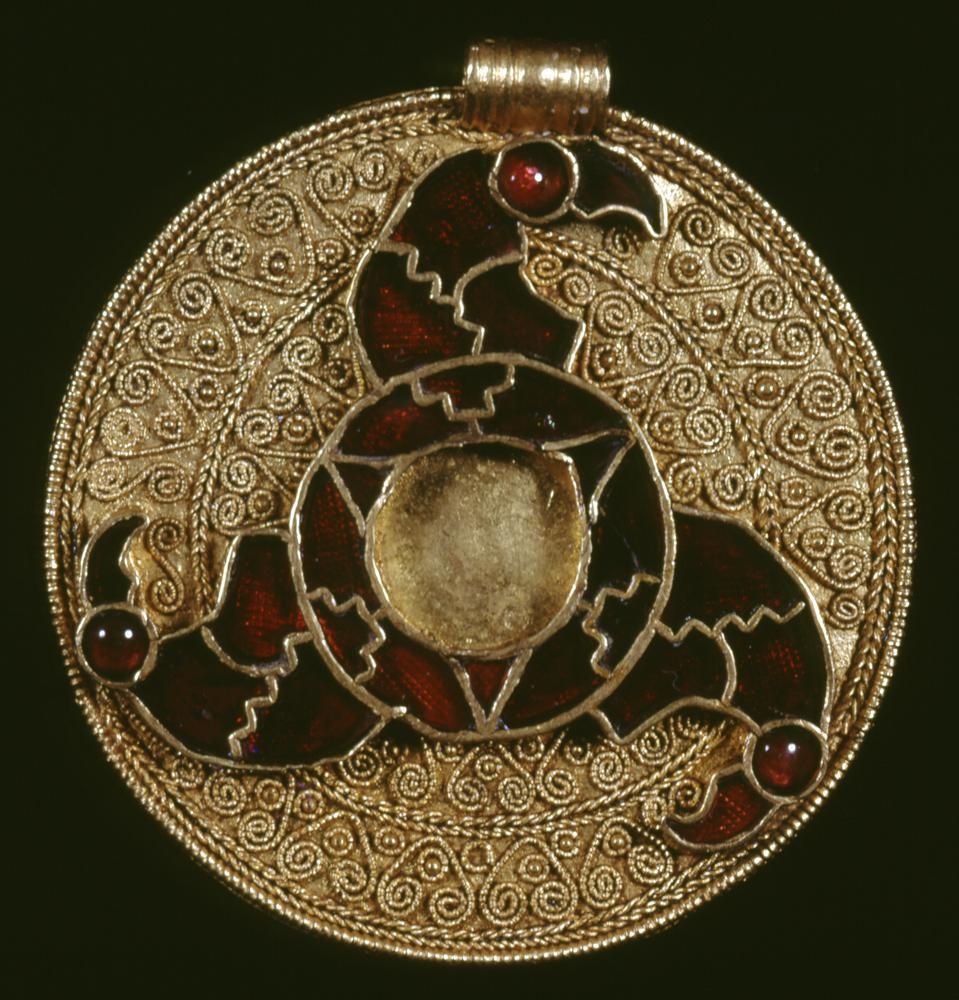 Gold disc pendant with cloisonné triskele of bird heads, 7th century. The British Museum.