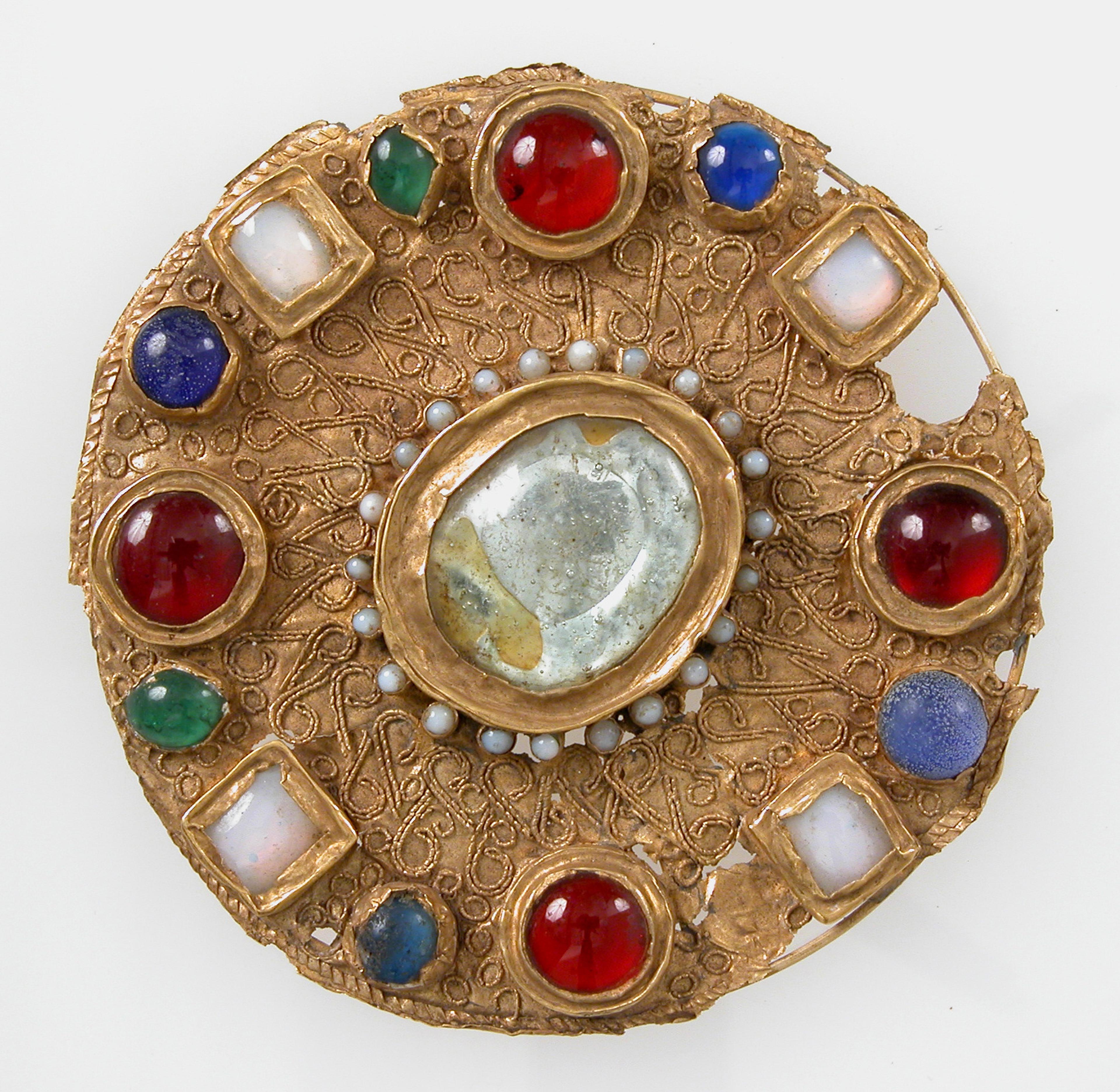 Glass stones set in a disk brooch, c. 7th century. The Metropolitan Museum of Art.