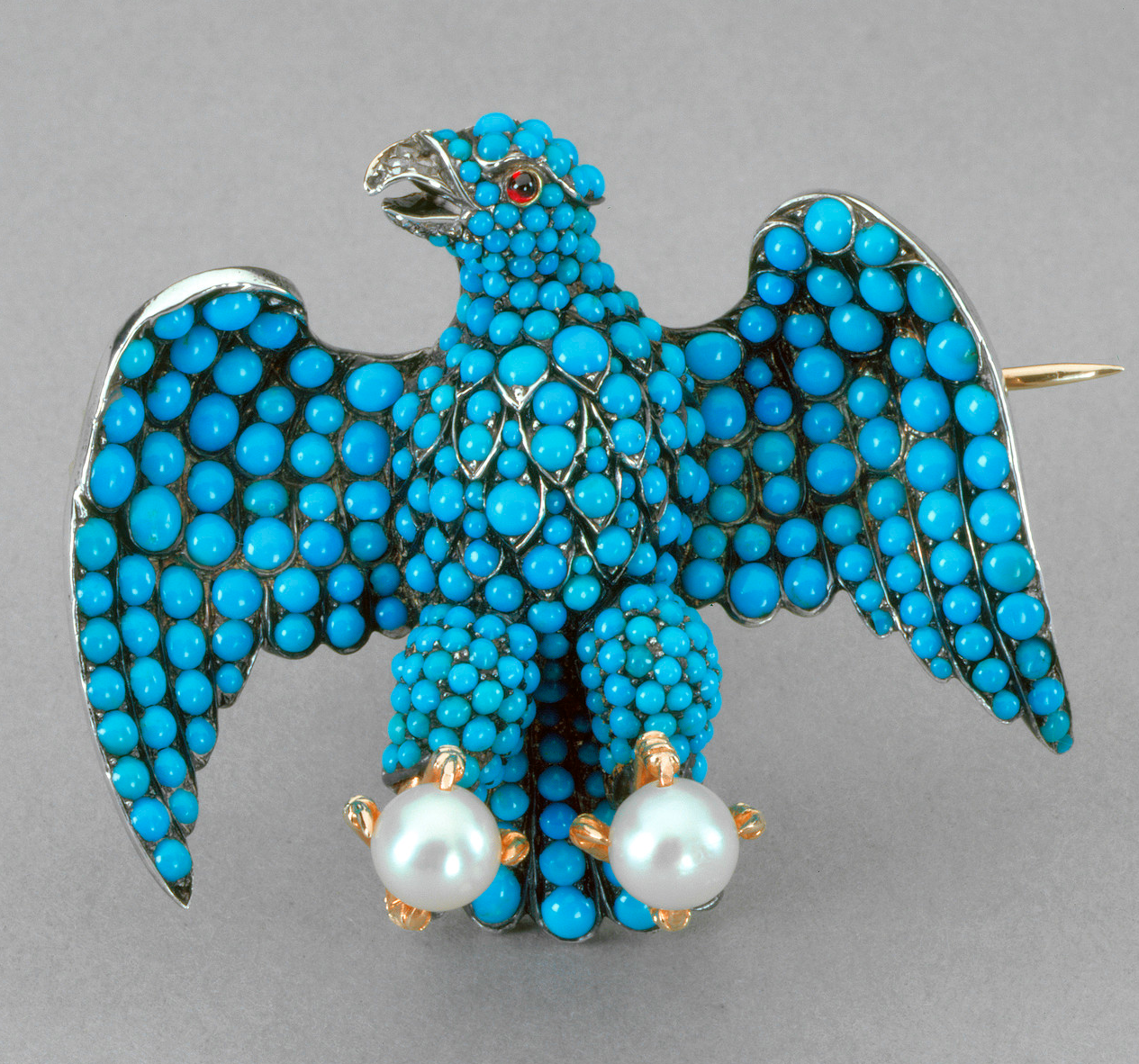 Prince Albert designed this eagle brooch that was given to each of Queen Victoria's train bearers. It has a turquoise form, diamond beak, ruby eyes and is grasping two large pearls in its claws.Brooch in the form of a German eagle, 1840. Royal Collection Trust.