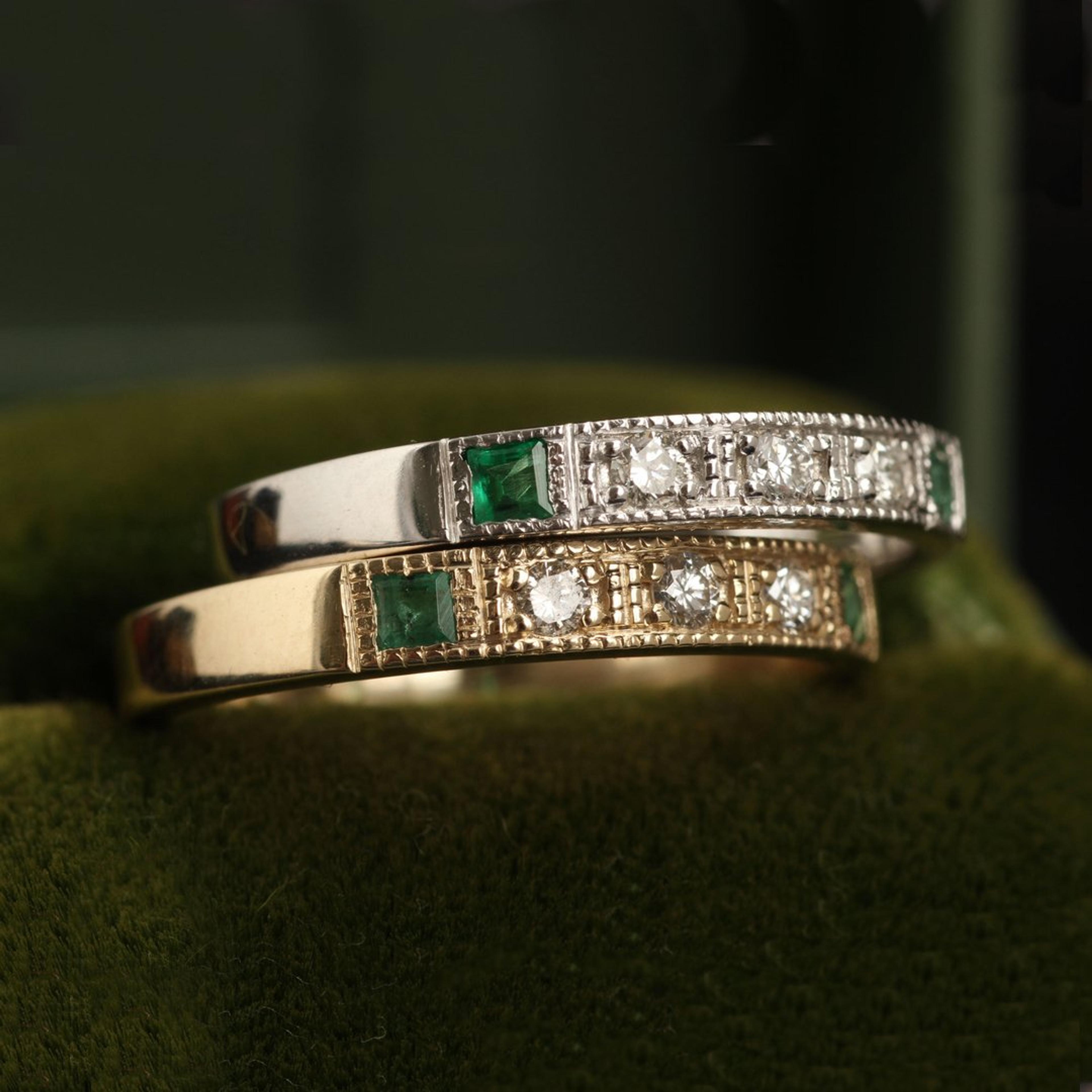 Detail of two Esther Rings, one white gold with emeralds, one yellow gold with emeralds