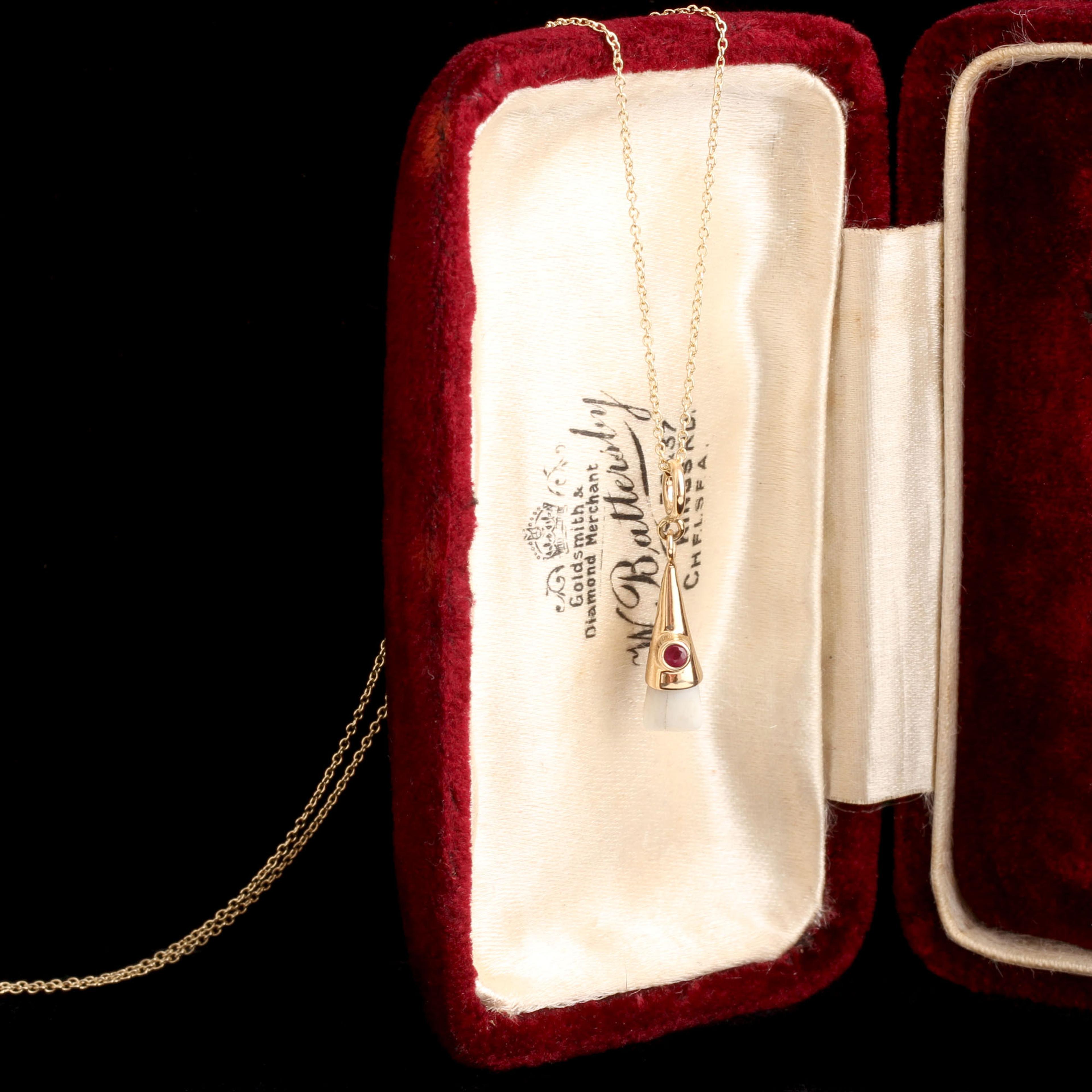 Baby tooth necklace set with a ruby