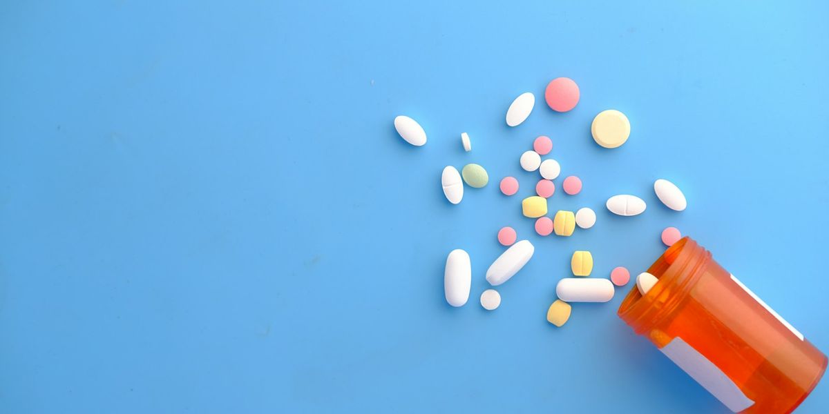 Tablets and a bottle on a blue background