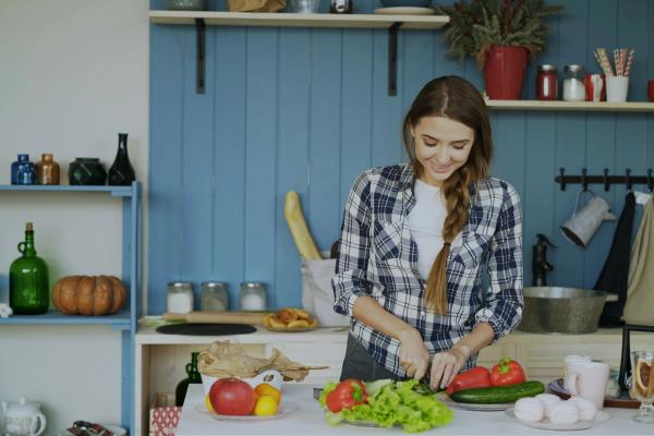 A woman preparing fresh vegetables in her kitchen
