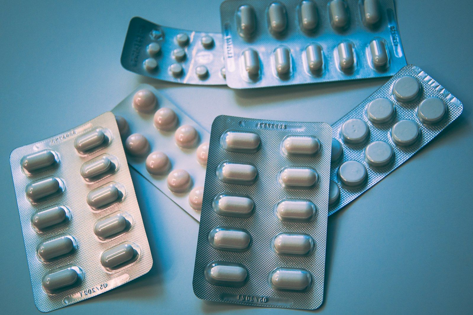 Blister packs of tablets on a blue background