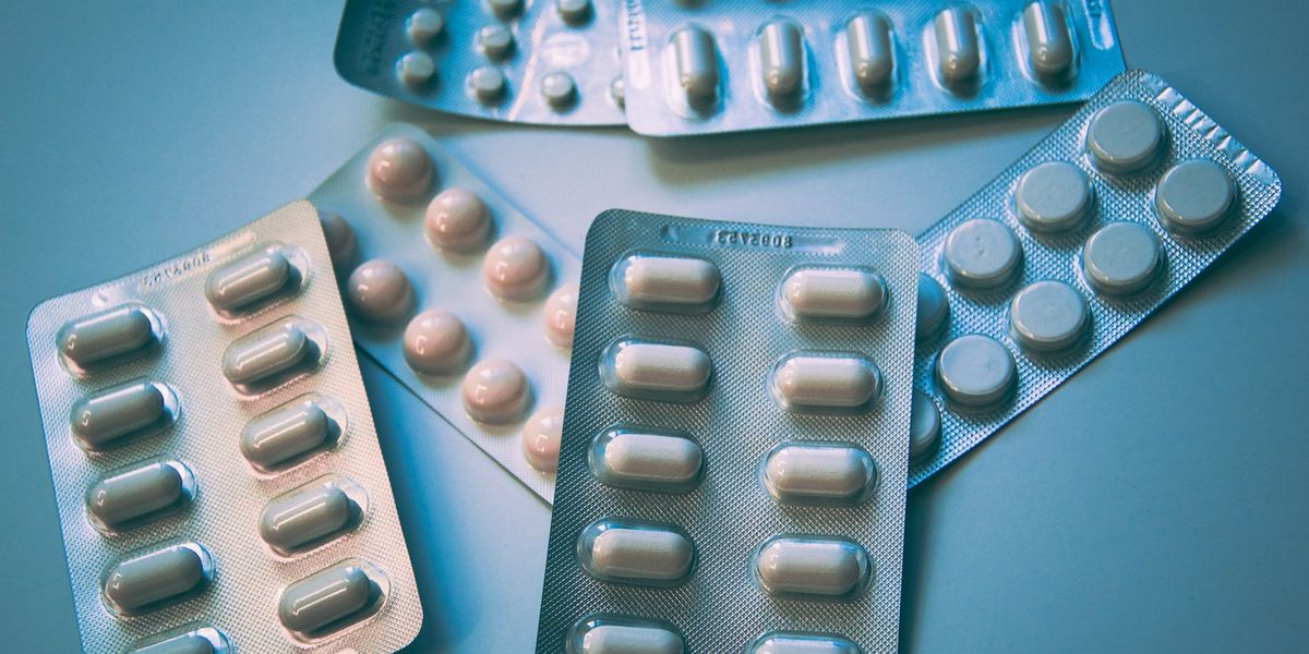 Blister packs of tablets on a blue background