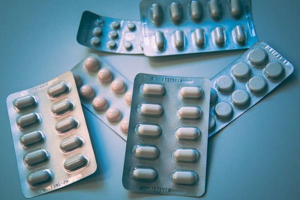 Blister packs of tablets on a blue background