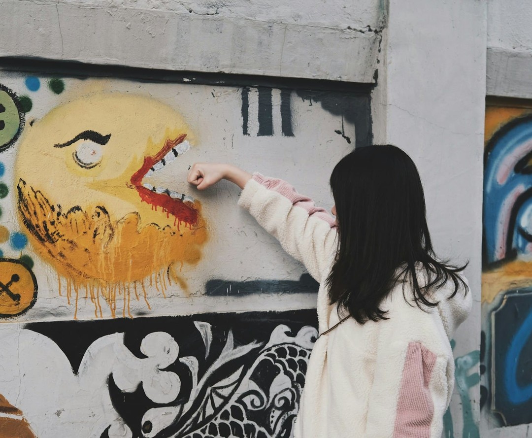 Dziecko maluje graffiti na ścianie