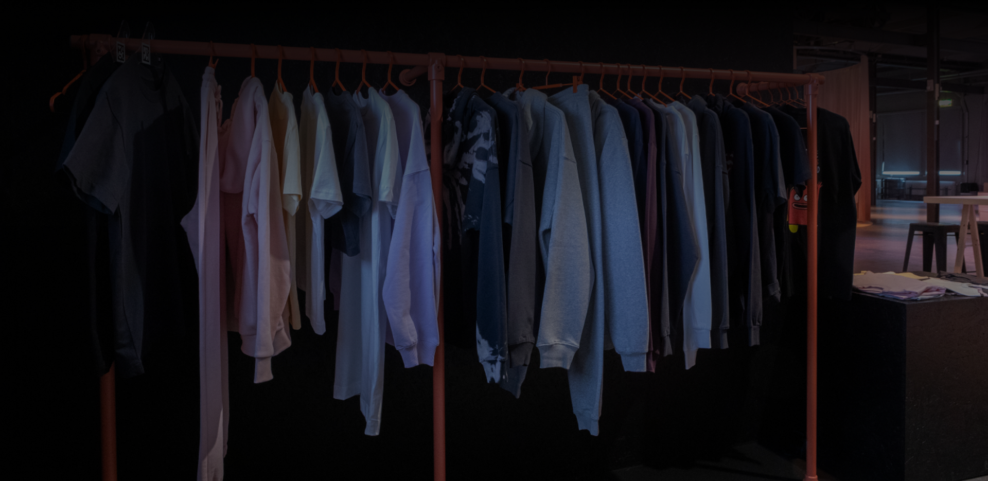 A collection of True Blanks garments hanging on a clothes rack