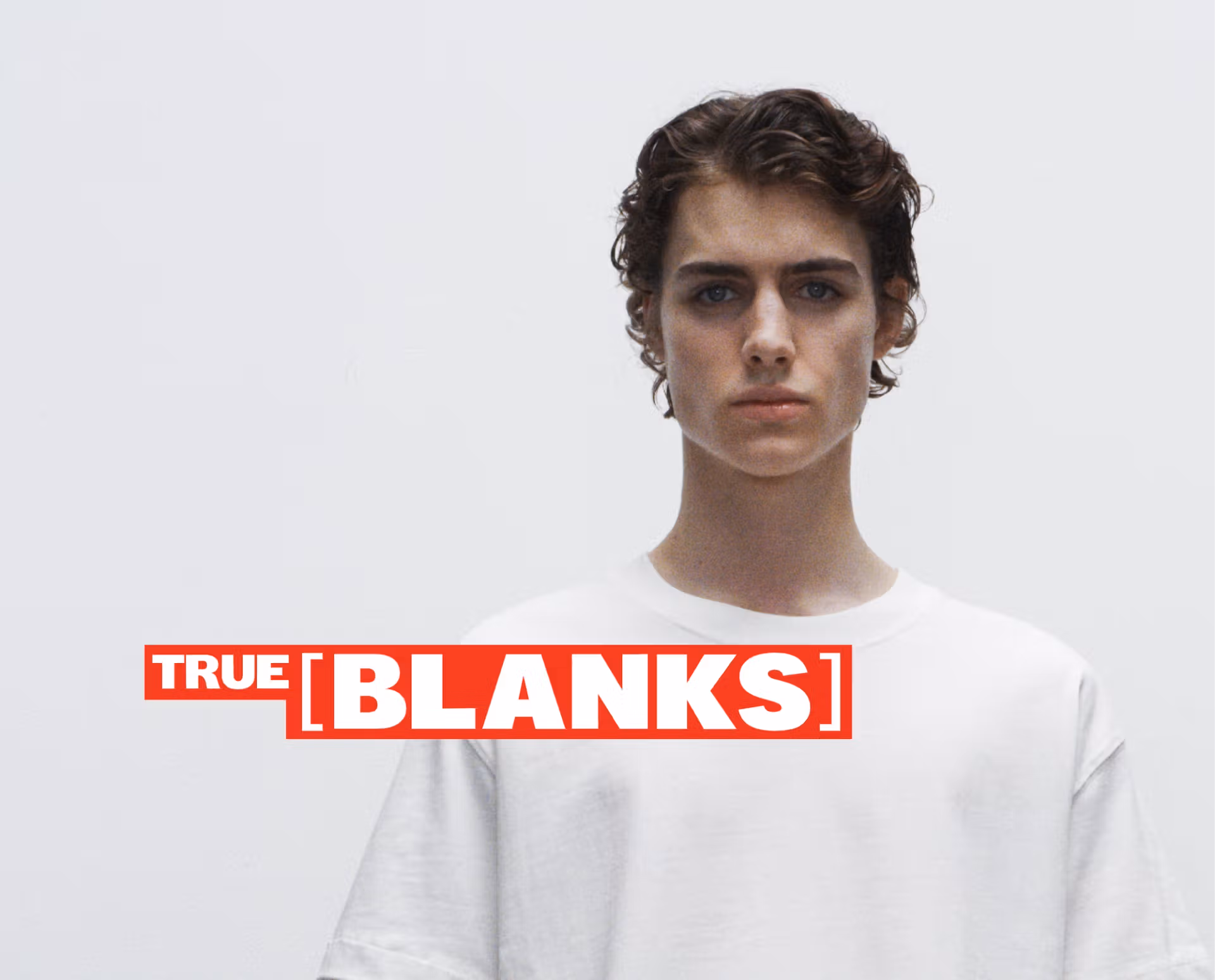 A male model wearing a white tee and a True Blanks logo