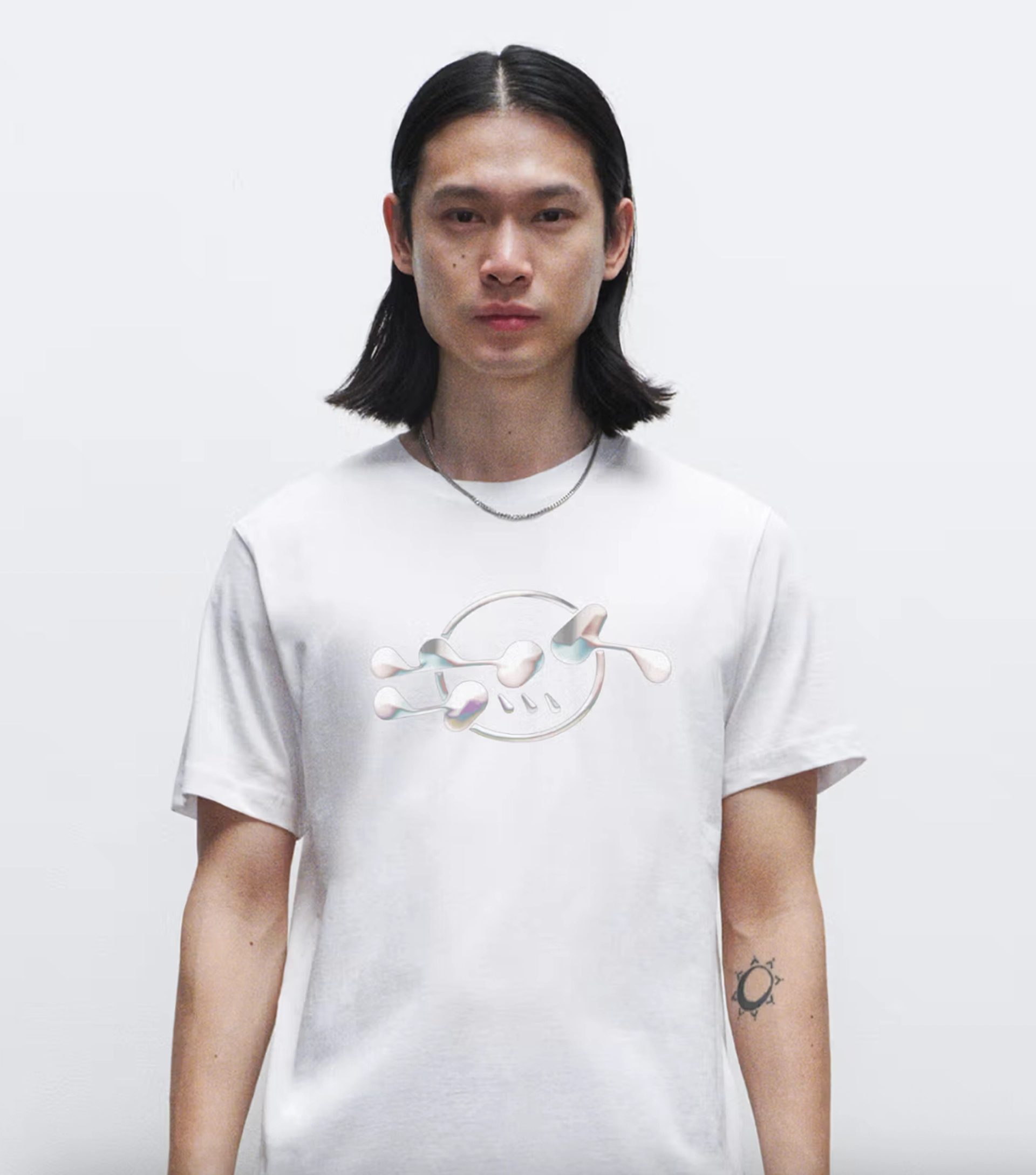 A male model wearing a Creator Studio printed white T-shirt