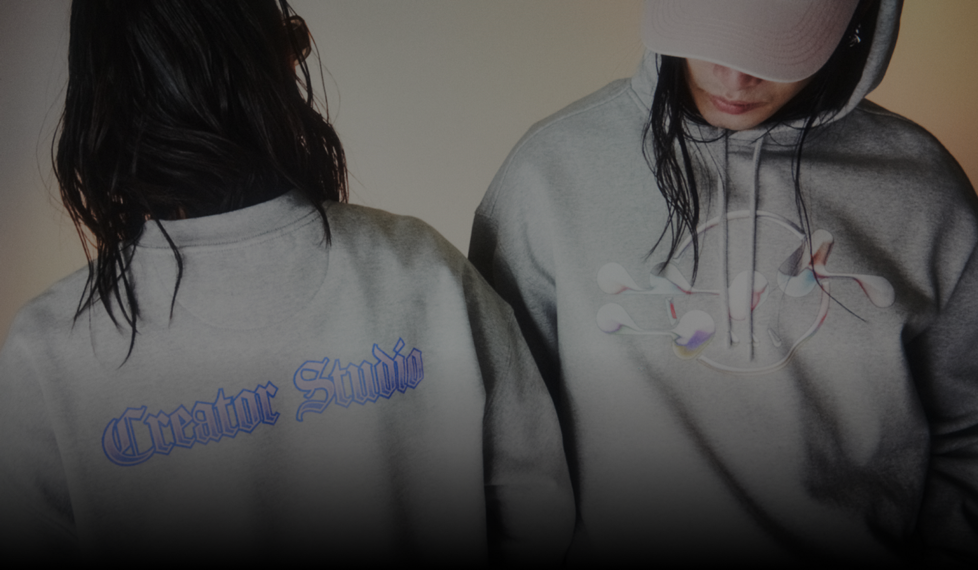 Two models wearing Creator Studio hoodie and sweatshirt.
