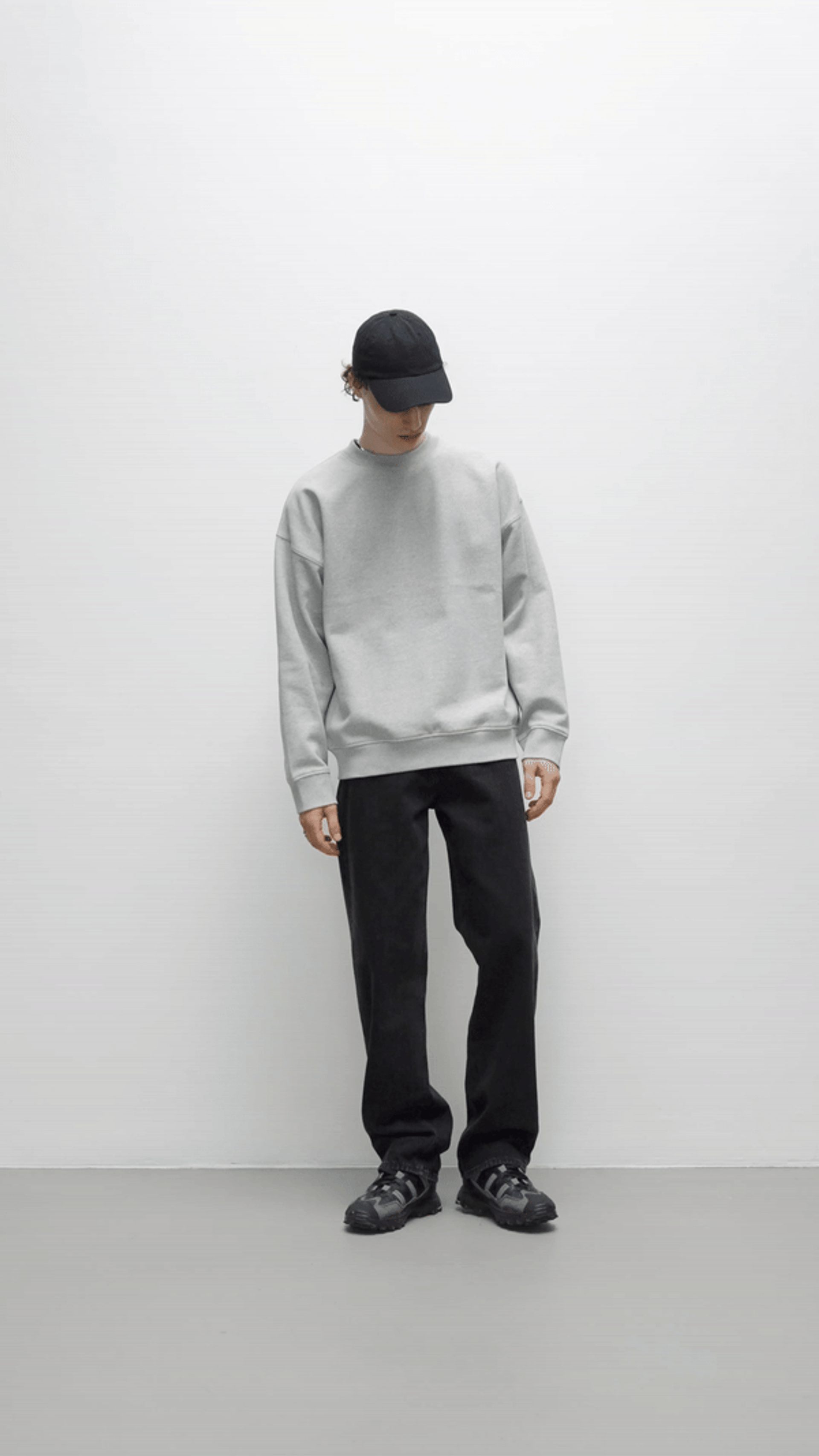 A male model wearing a Creator Studio grey hoodie