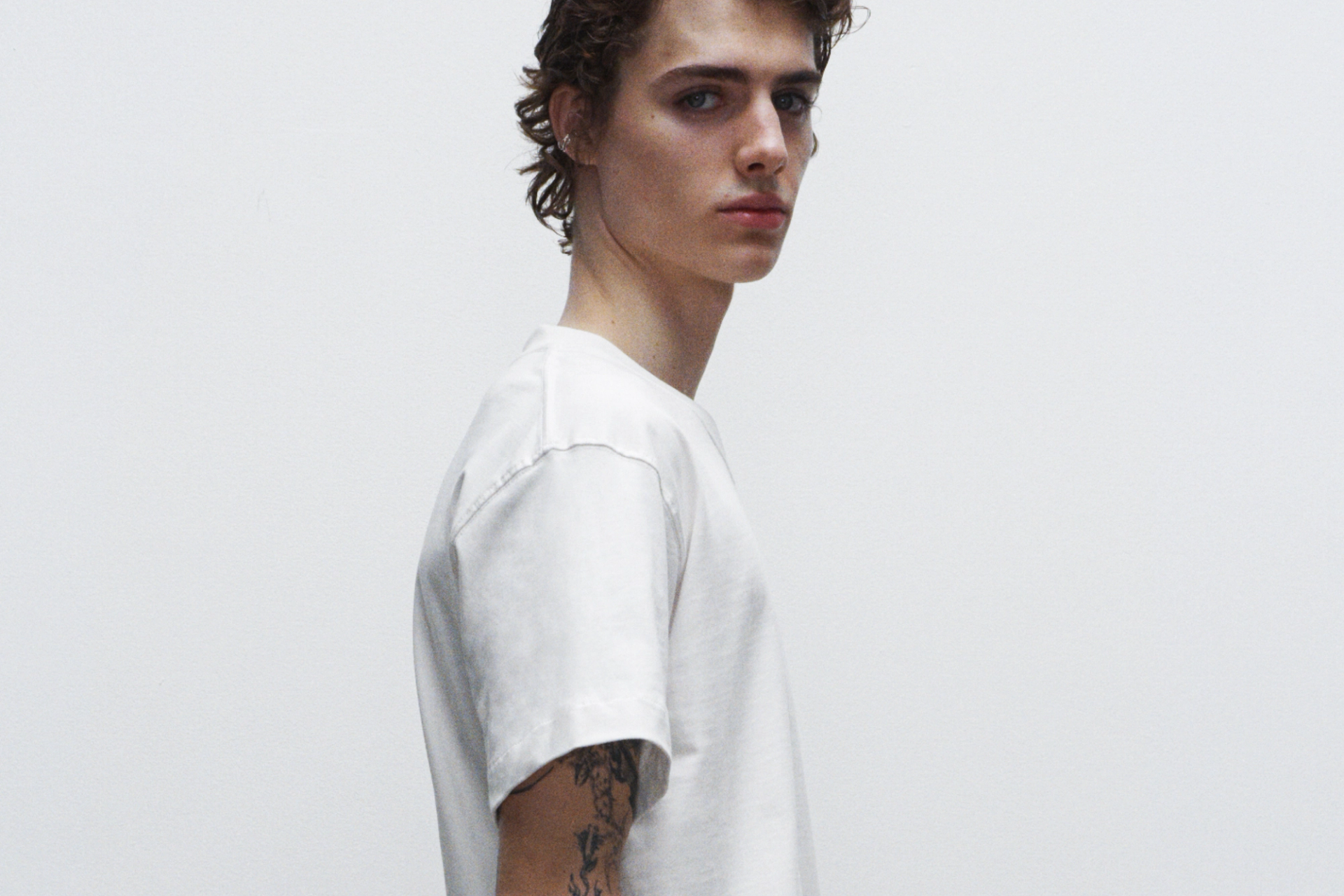 A male model wearing Creator Studio contemporary T-shirt