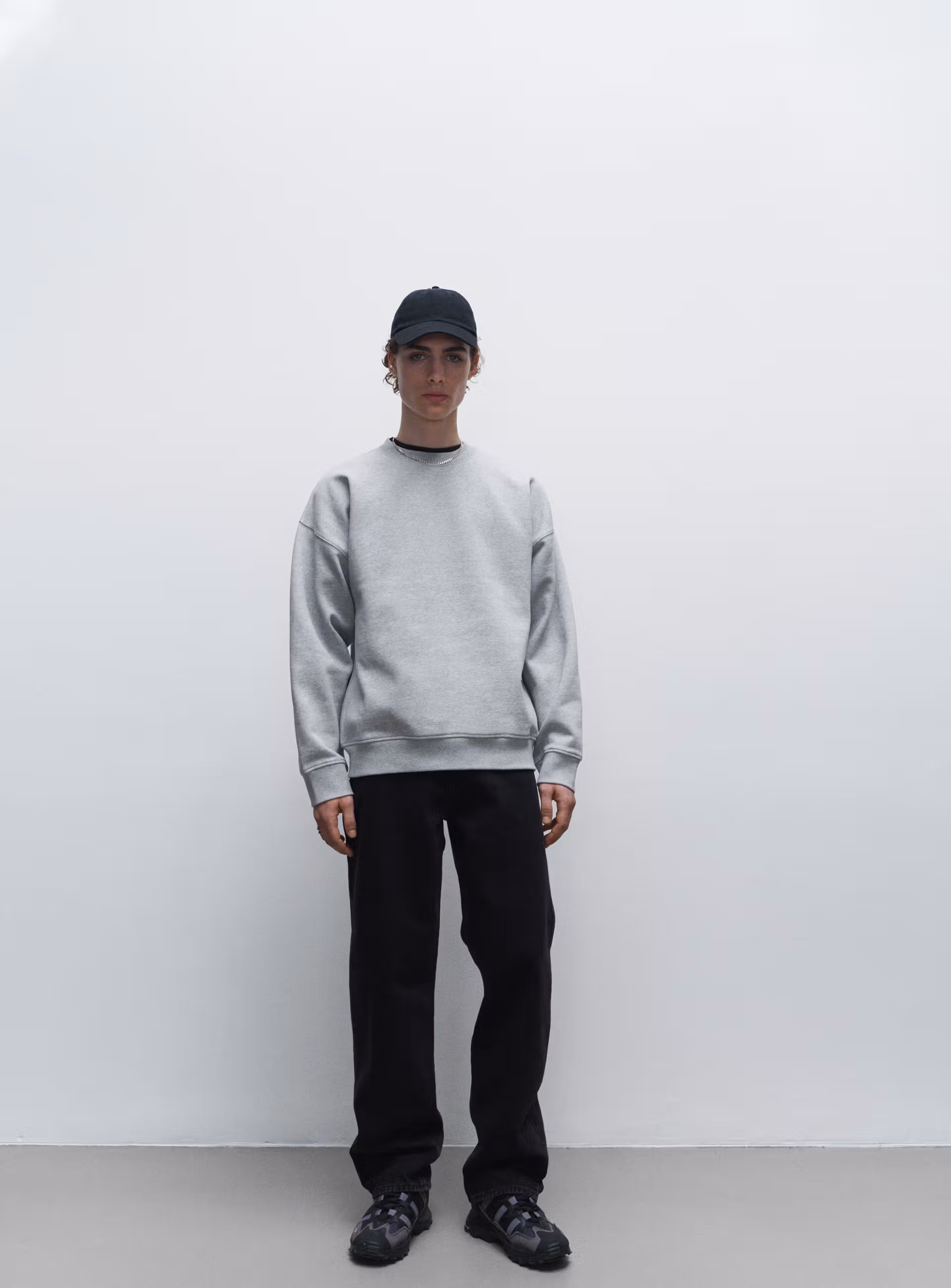 A male model showing a grey sweatshirt