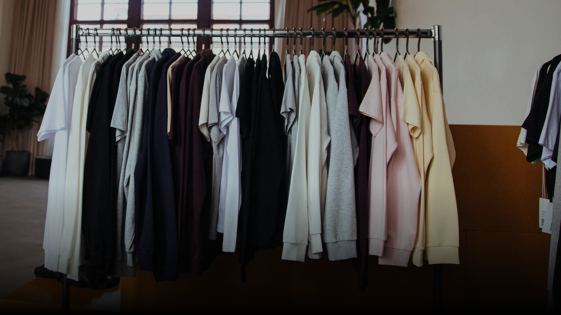 A collection of True Blanks garments hanging on a clothes rack