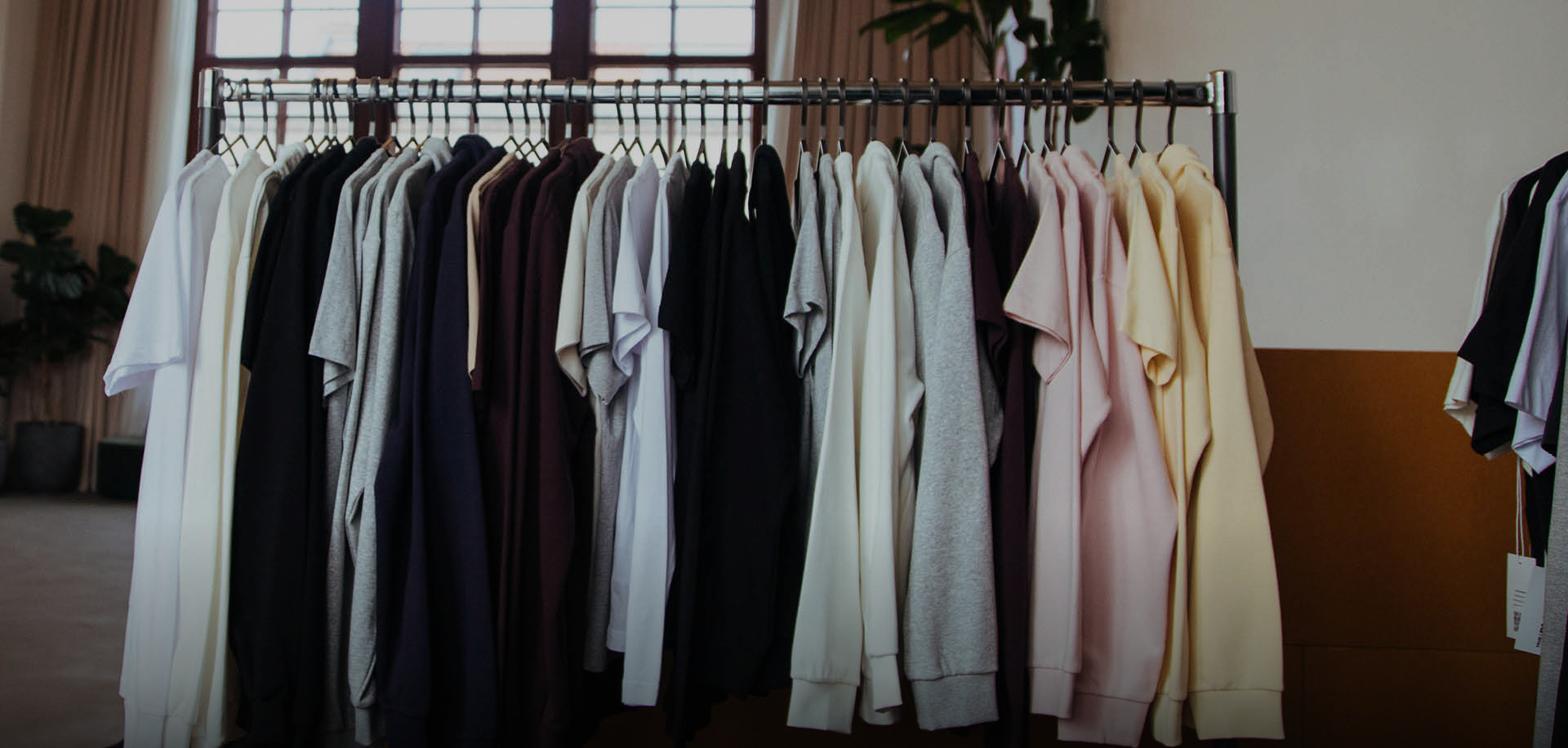 A rack of custom printed sports team kit hands together