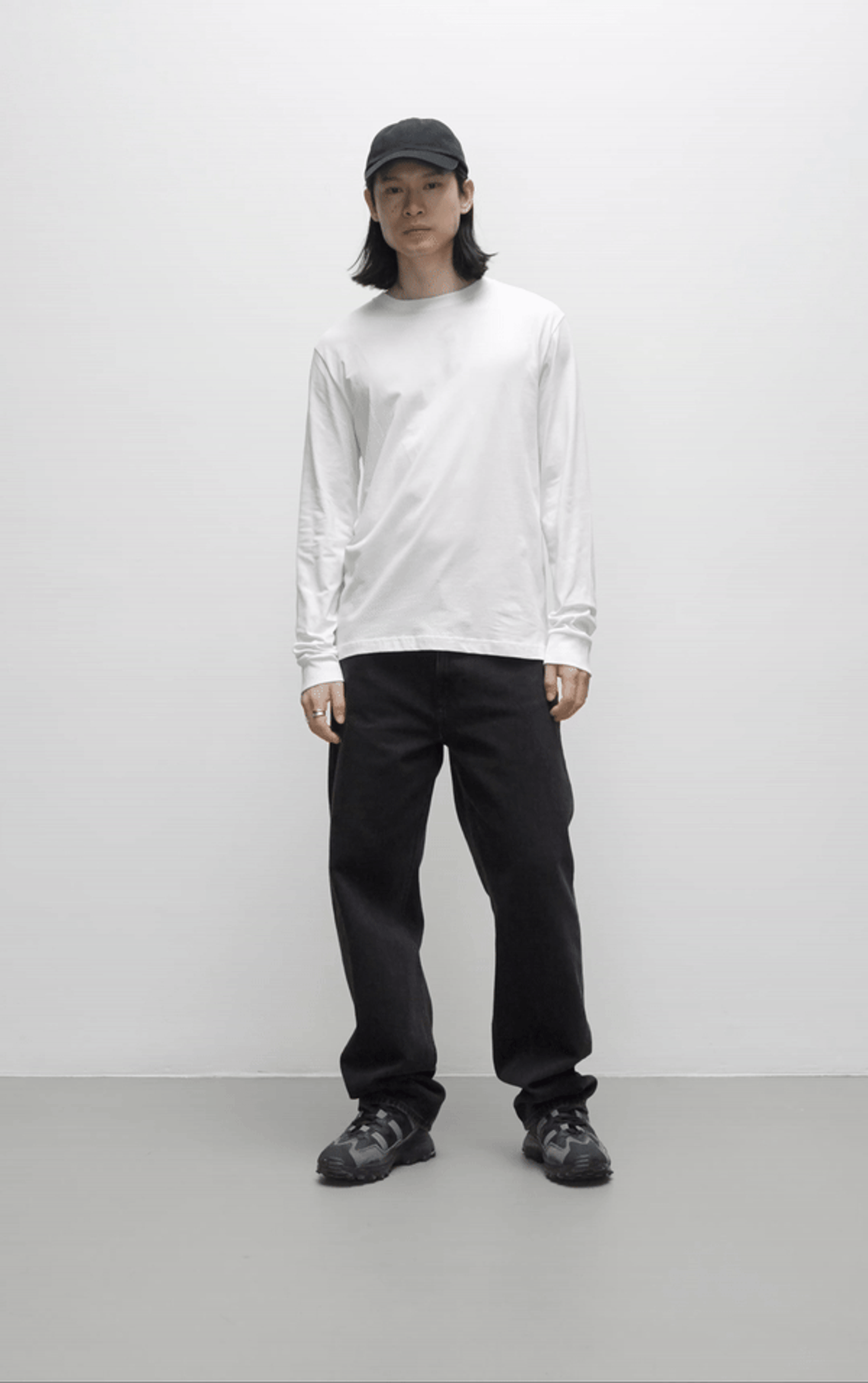 A male model wearing a white long sleeve