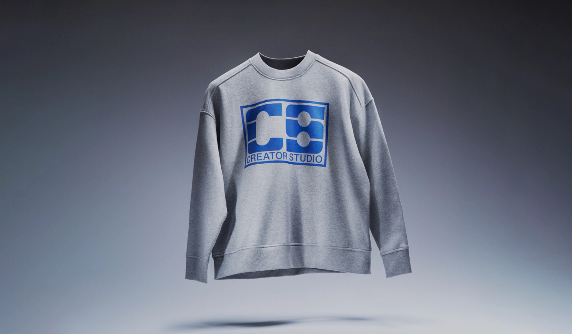 Grey Sweatshirt floating with Creator Studio logo in blue
