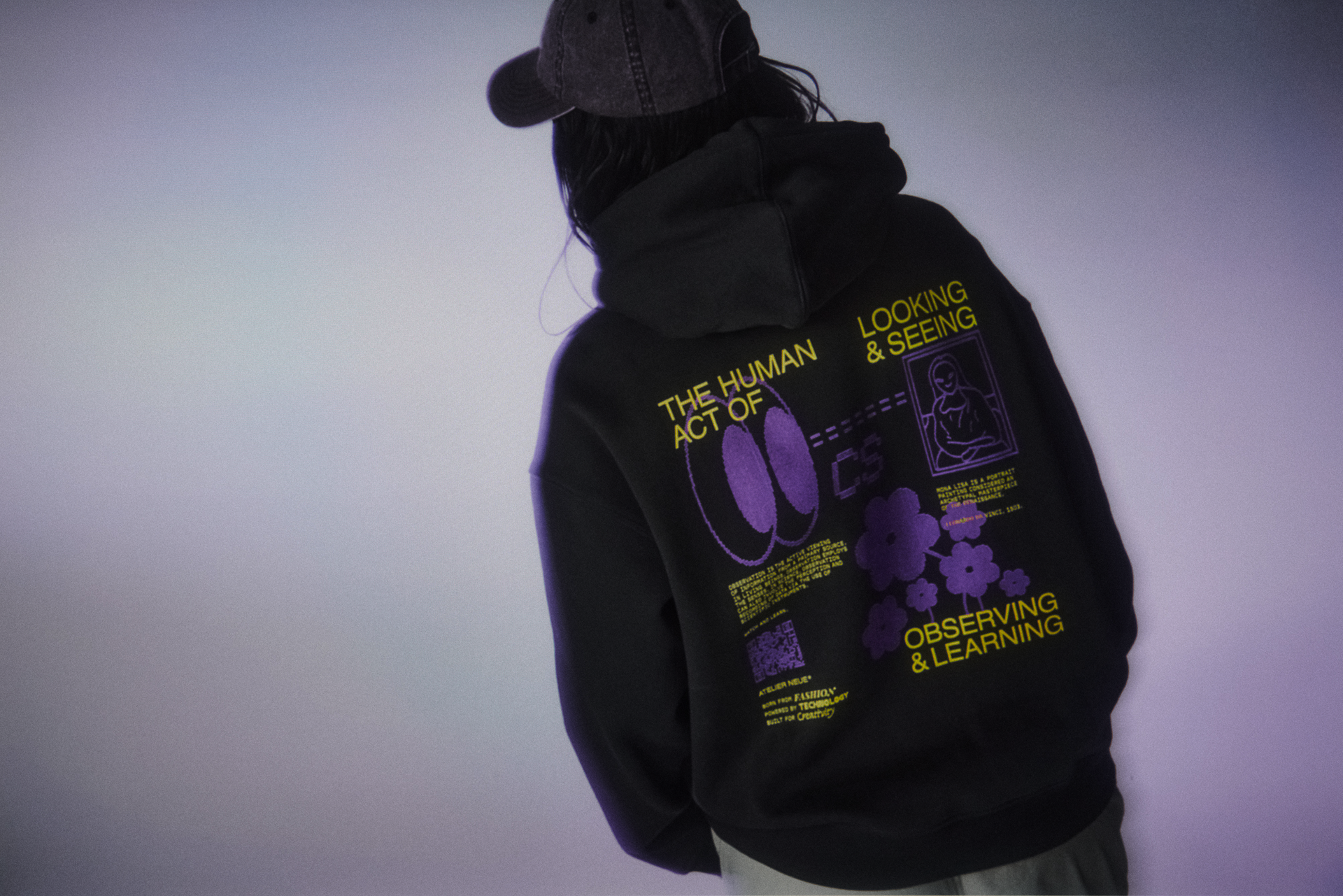 A model wearing a black sweatshirt with custom back print