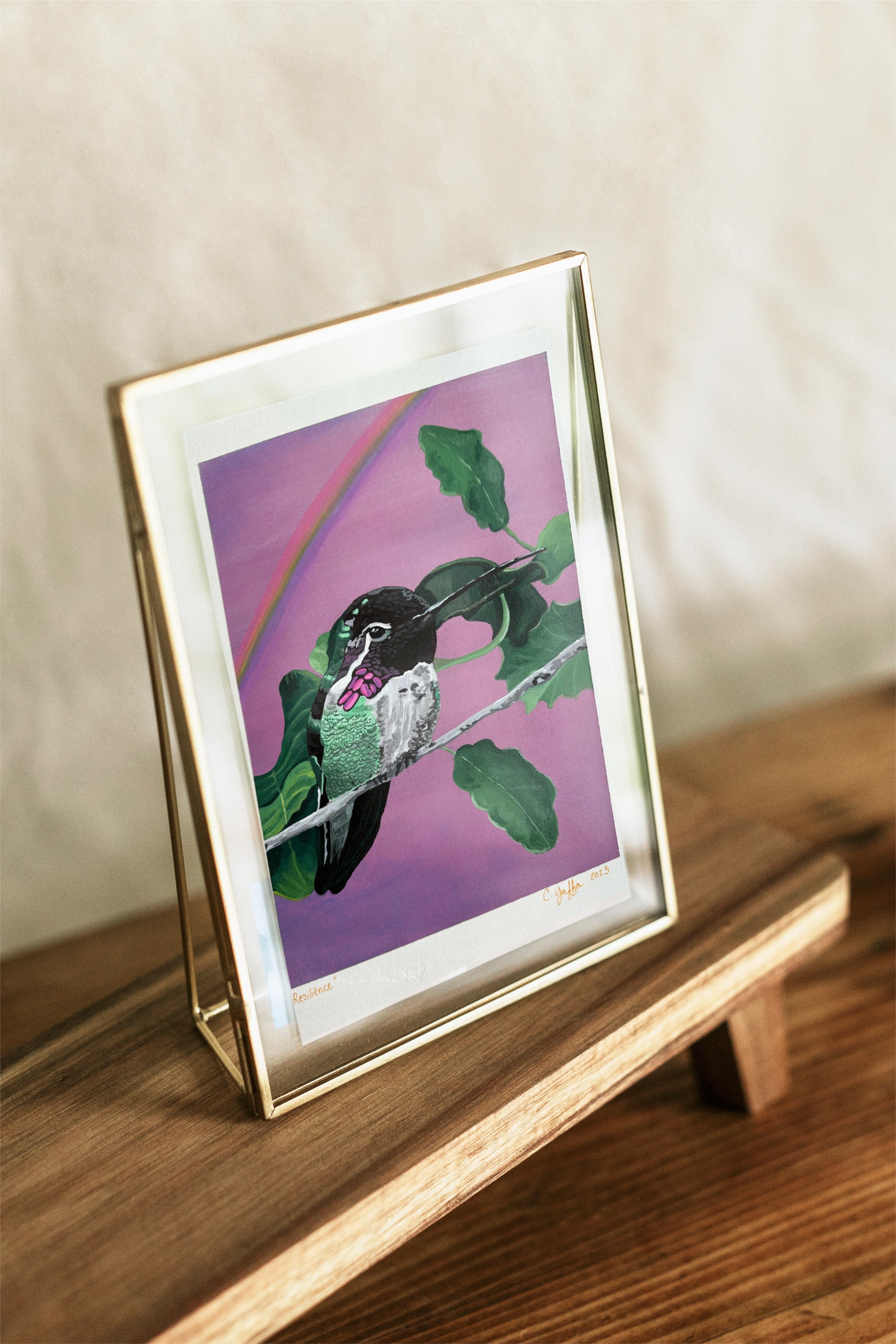 Original Acrylic painting of a Costas hummingbird. The bird sits on a leafy twig with a purple sky and slight rainbow in the background.